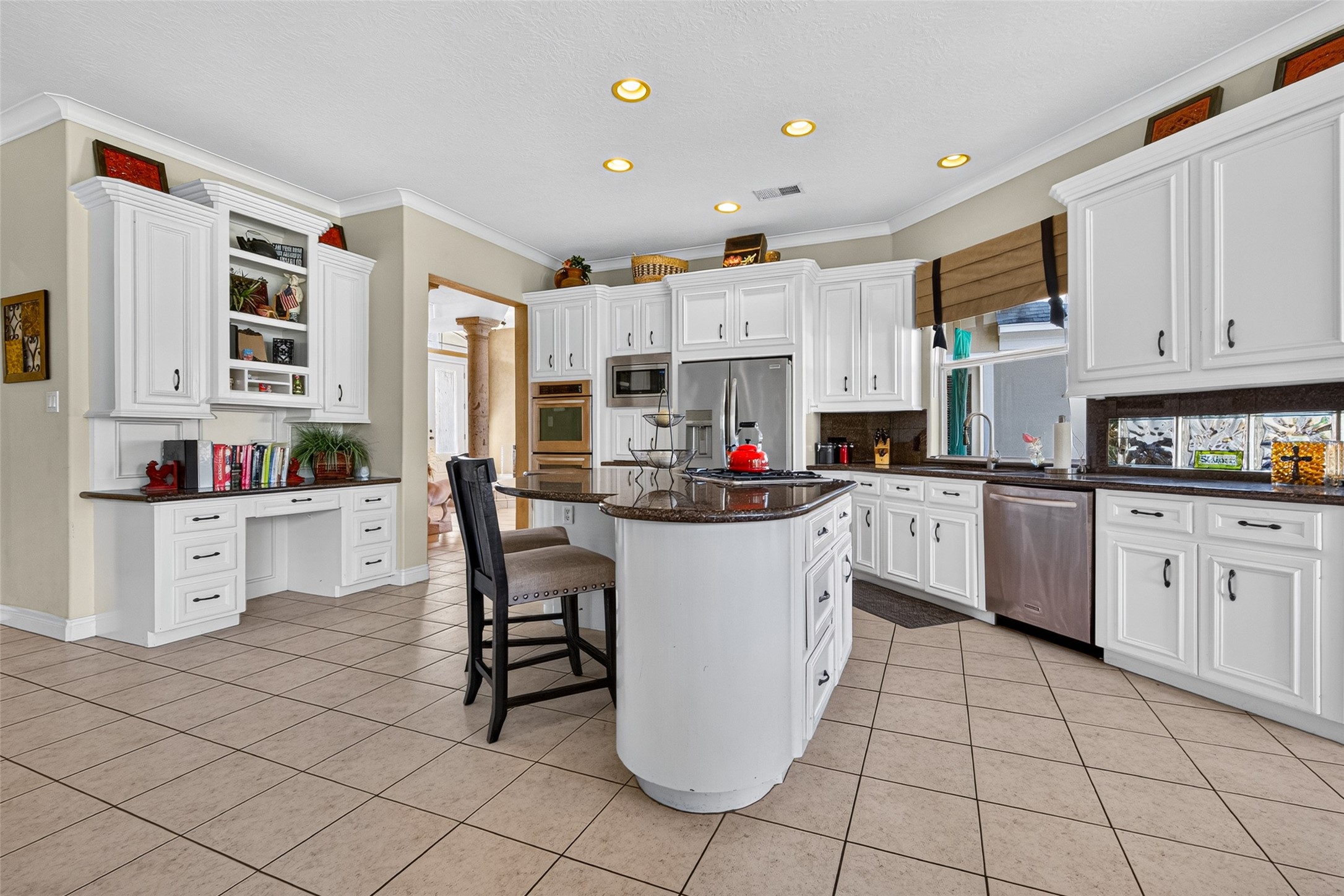 Look at this wonderful kitchen!  It features granite counter tops, a fabulous island w/ cooktop, stainless appliances, a double oven and an abundance of storage and cabinet space.