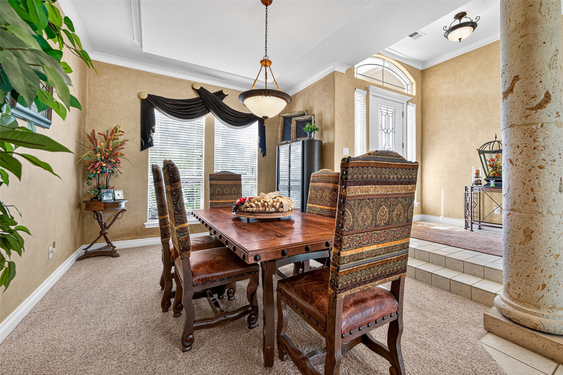 The formal dining room is located between the kitchen and the formal living room