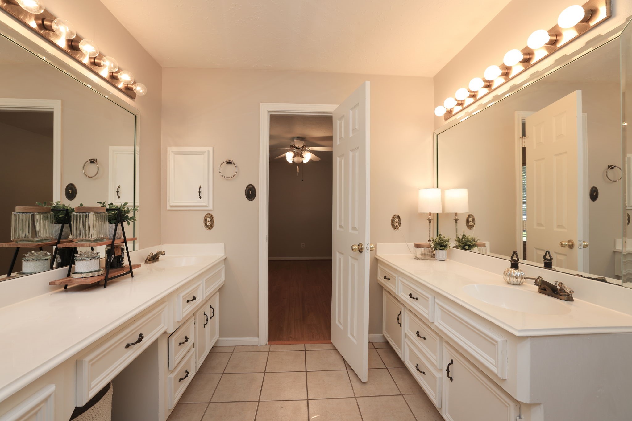Spacious secondary bath with double sinks and convenient access to adjoining bedrooms.