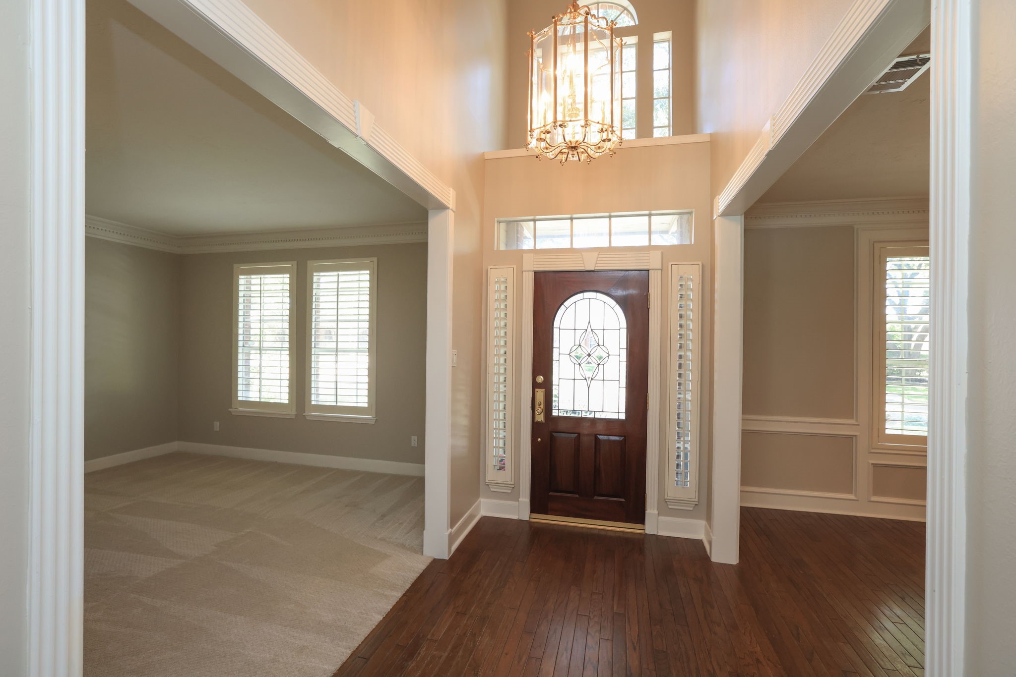 ALL NEW INTERIOR PAINT NEW! Bright two-story foyer with gleaming hardwood floors, custom millwork, and natural light from transom windows.