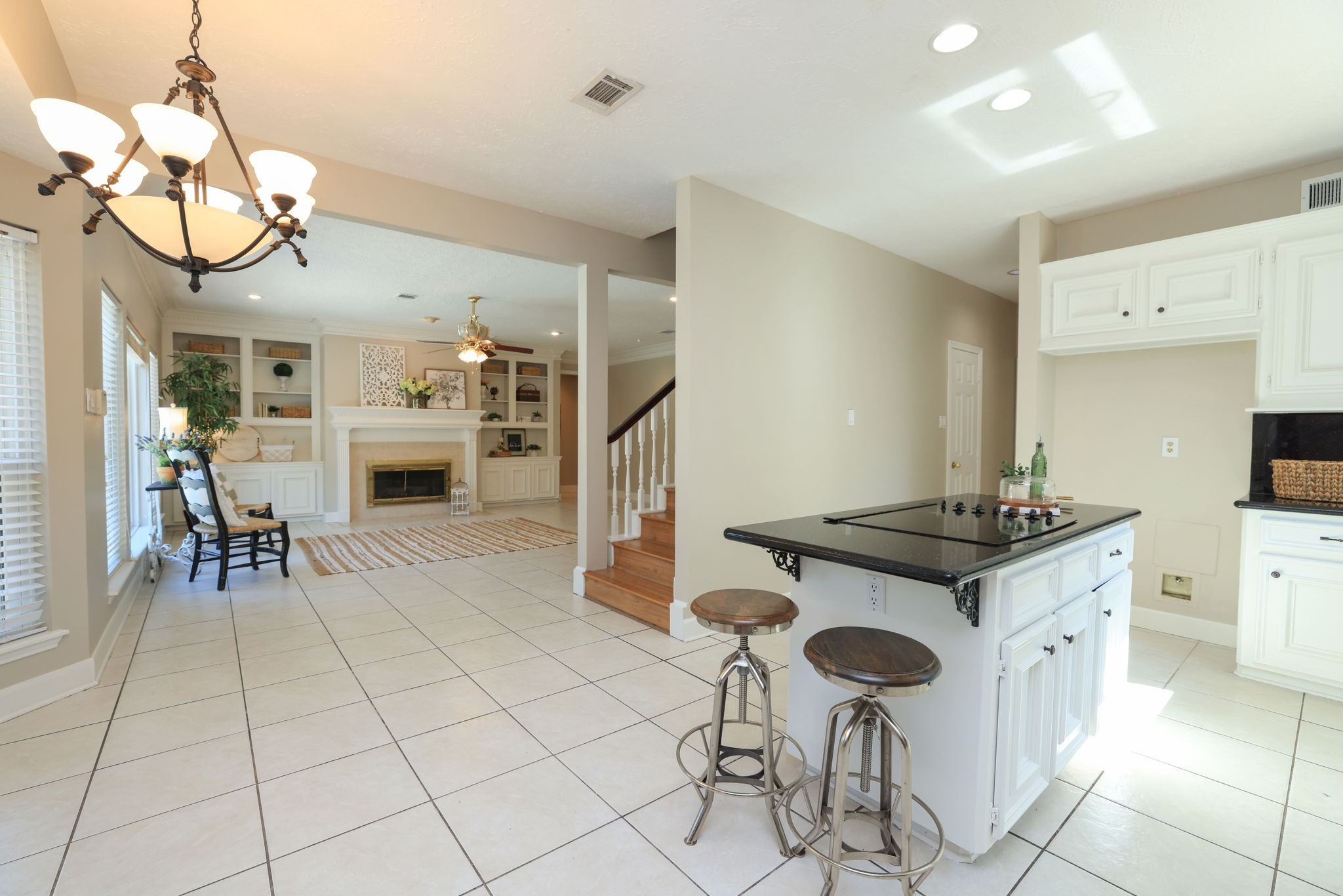 Kitchen opens directly to the family room, both with tile floors and island seating.
