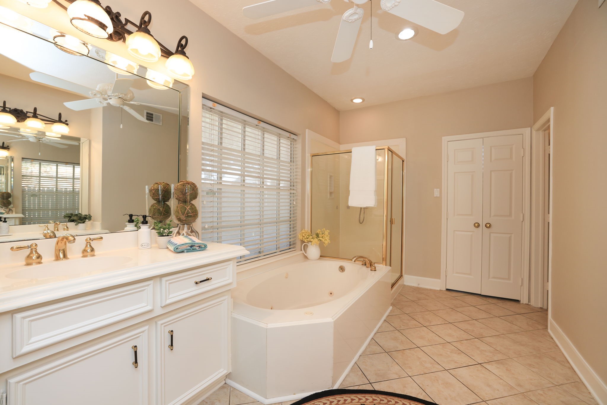 Generous vanity space with updated lighting, mirrors, and a spa-inspired layout.