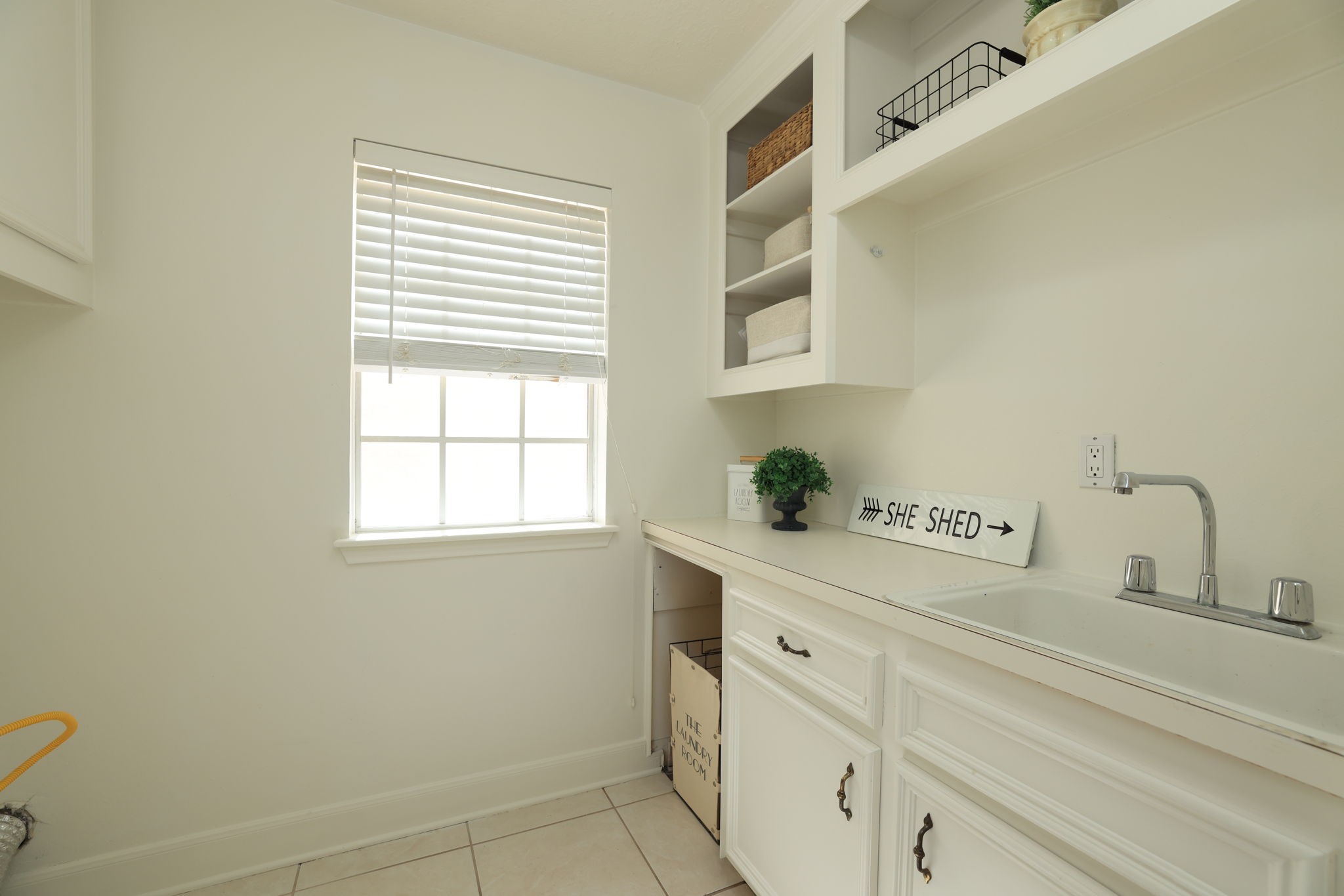 Convenient laundry area with built-in cabinets and ample workspace, perfectly located near the kitchen.