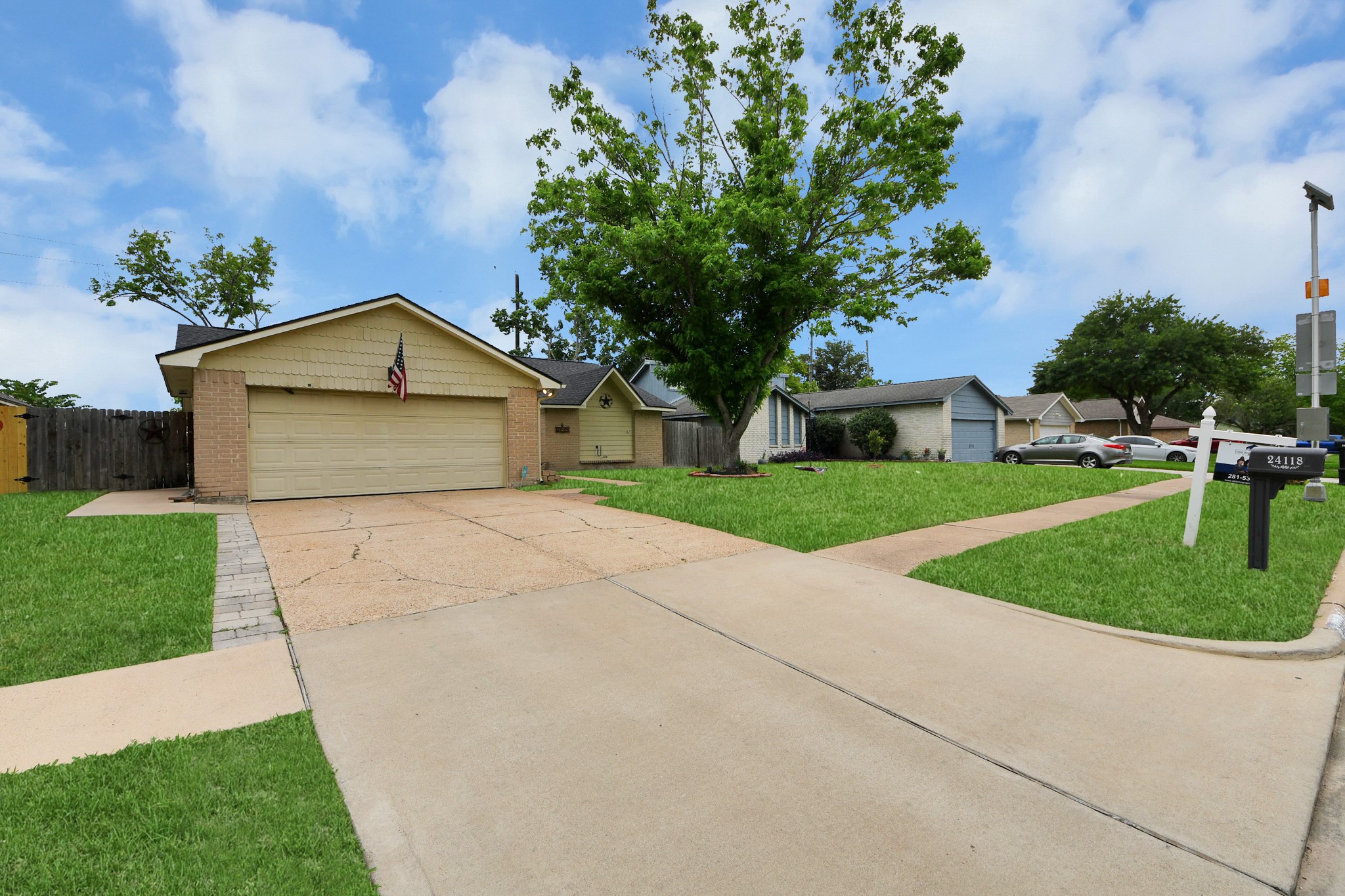 Charming single-story home with a two-car garage, nestled in a quiet neighborhood. It features a well-maintained front yard with a mature tree and a spacious driveway. Perfect for a cozy and convenient location.