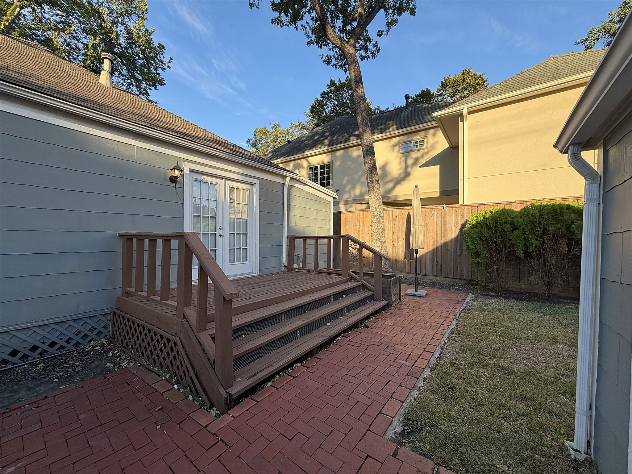 Backyard Deck: Elevated wooden deck overlooking the backyard, perfect for outdoor relaxation and entertaining.