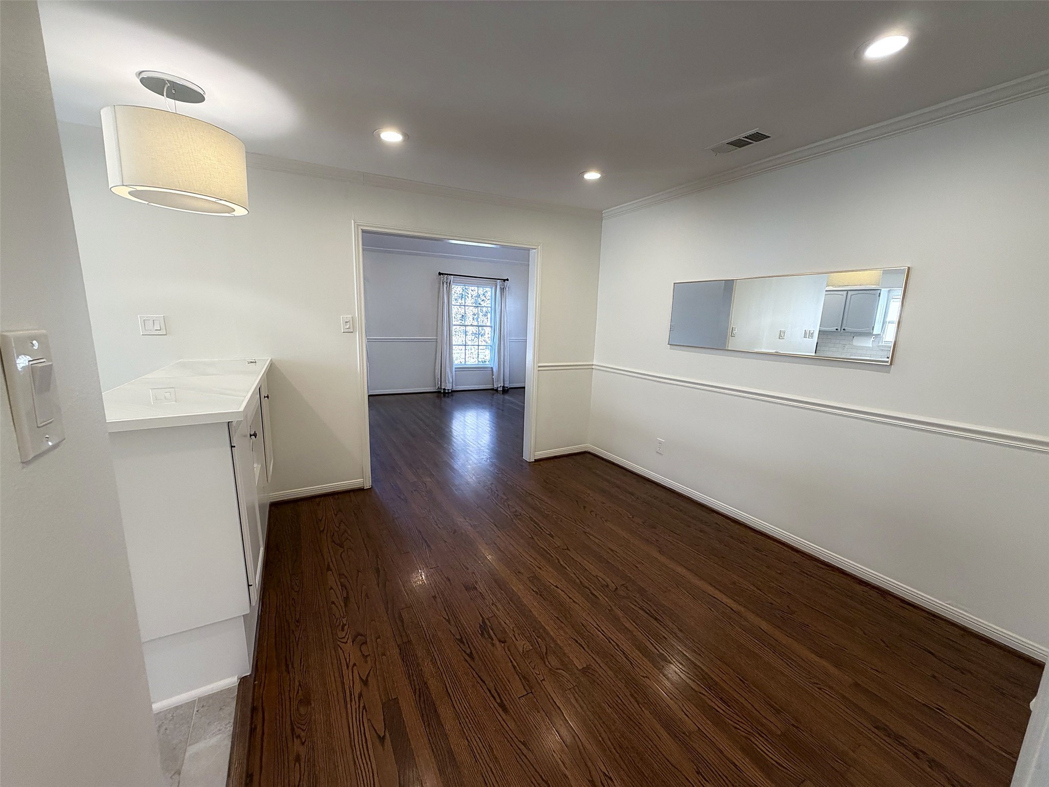 Dining Area: Cozy dining space that can accommodate a large wooden table, upholstered chairs, and an open connection to the kitchen.
