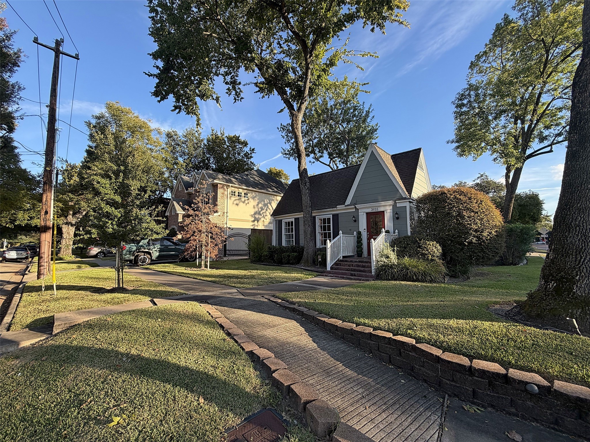 Street view of home on a tree-lined corner lot, just off of Rice Blvd