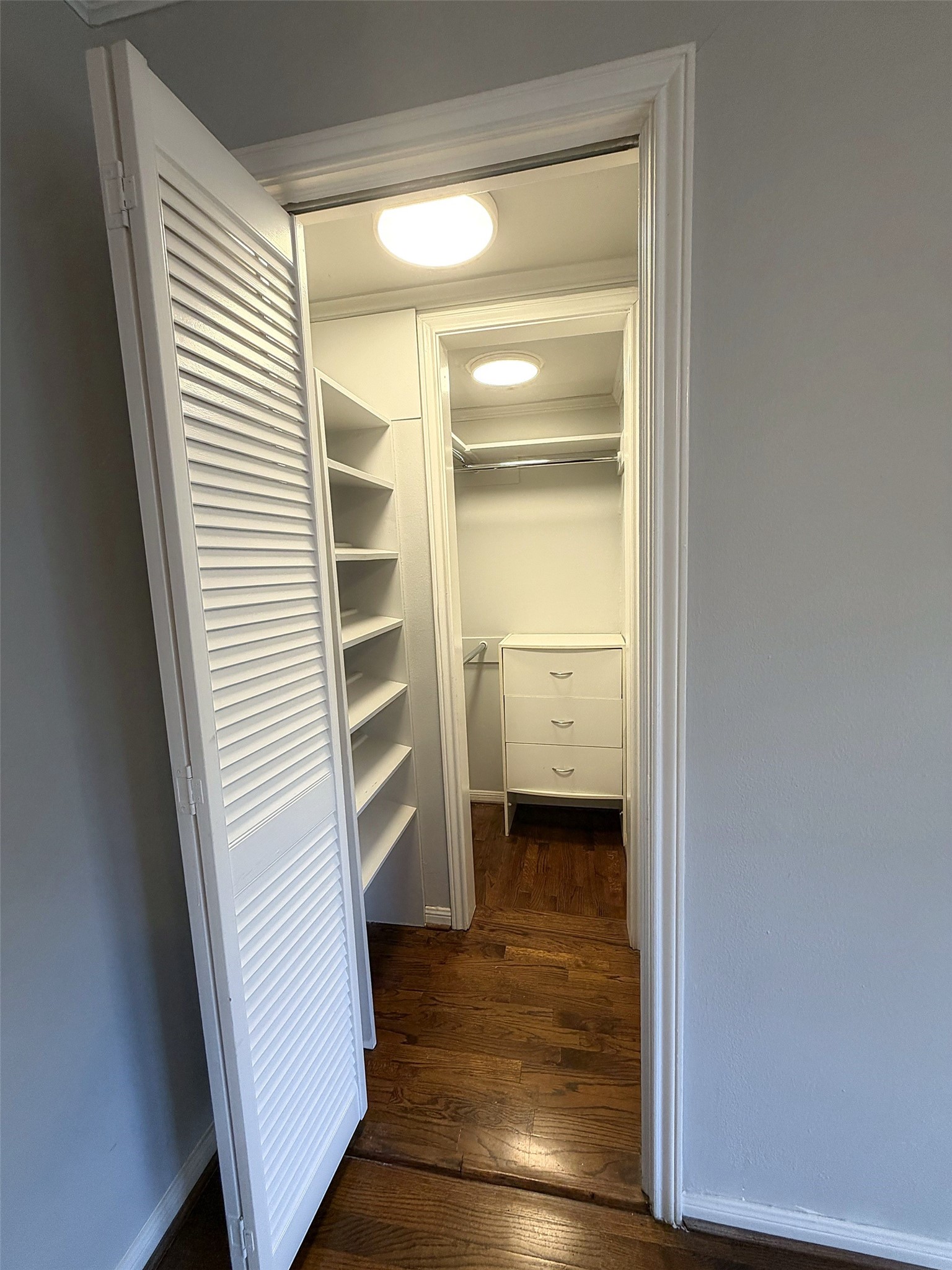 Bedroom  Second closet in primary bedroom with ample closet space, shelving and drawers.