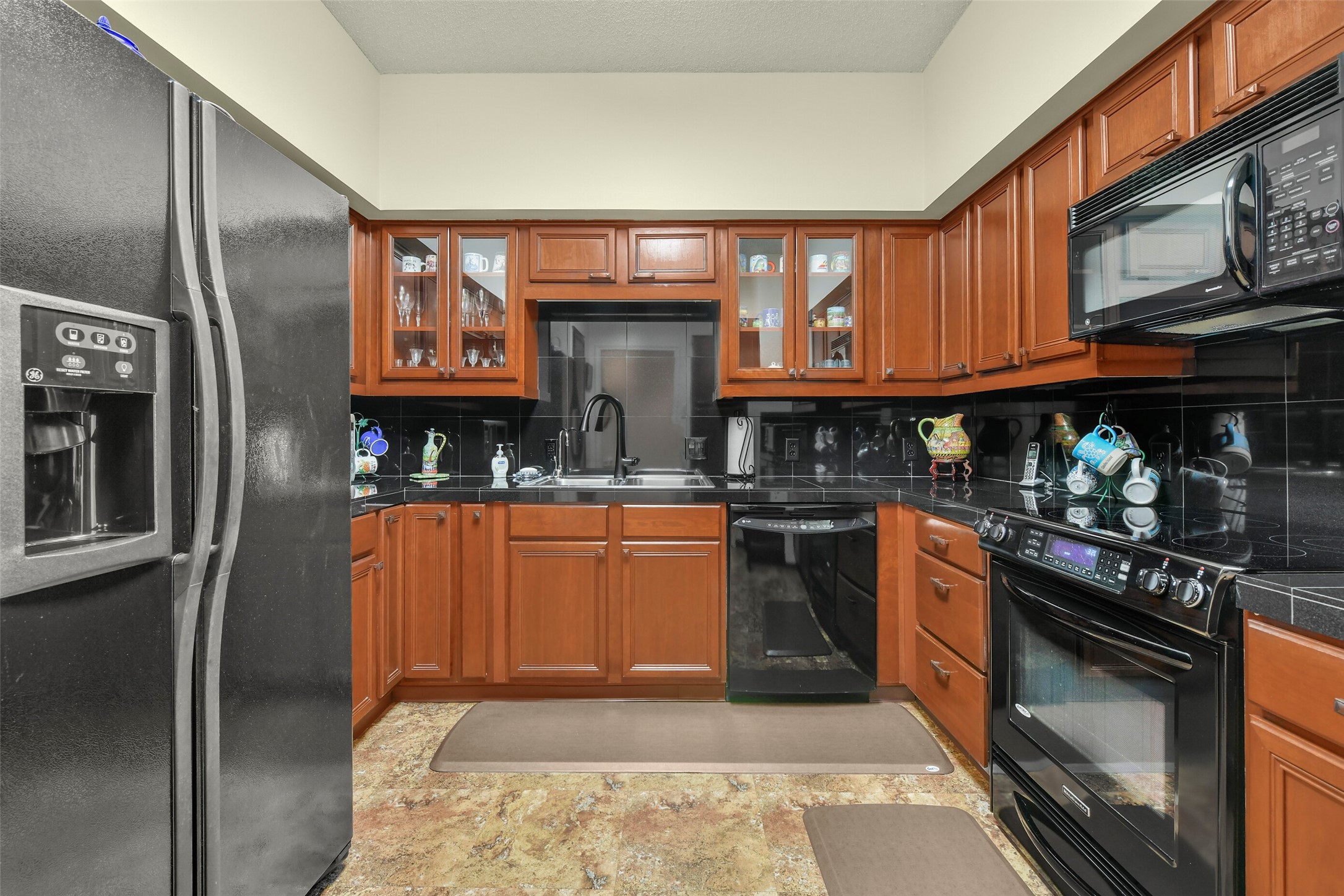 The handsome kitchen includes glass front display cabinets, a nice sized pantry, and plenty of storage. The handsome kitchen includes glass front display cabinets, a nice sized pantry, and plenty of storage.