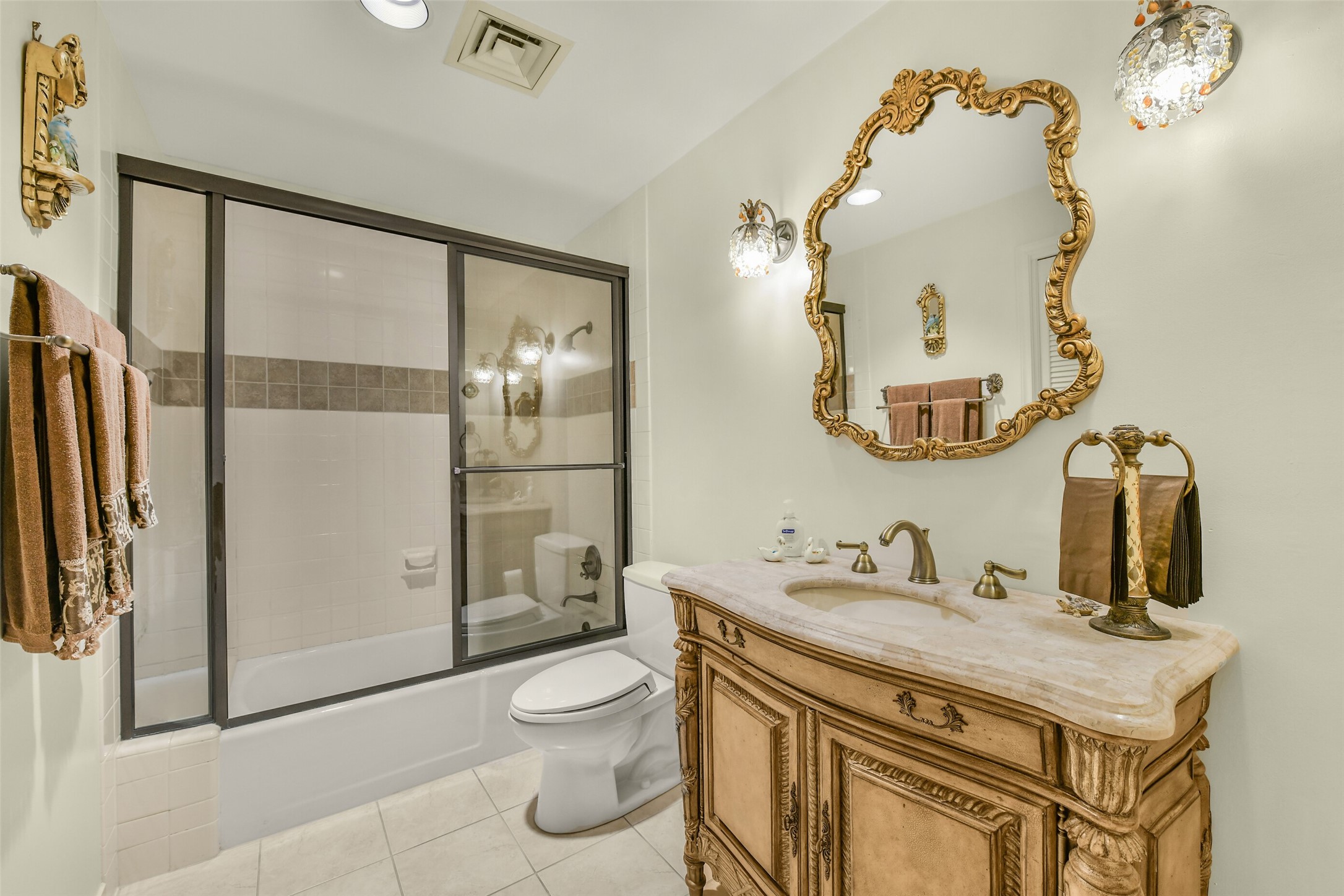 A charming guest bathroom includes a full shower/bath .