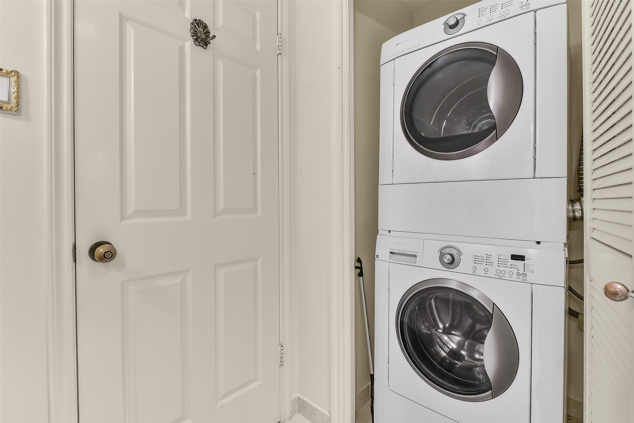 The guest bathroom includes a full-sized stack washer/dryer.