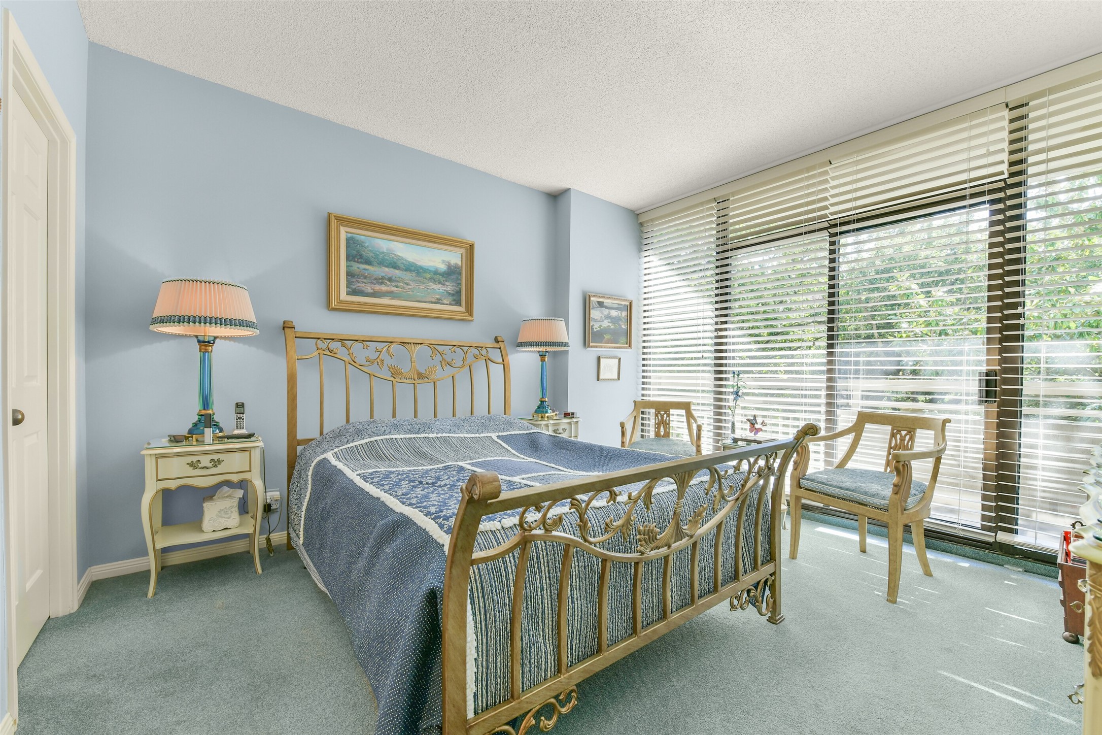 The primary suite overlooks the private balcony and includes an ensuite bathroom and walk-in closet. The primary suite overlooks the private balcony and includes an ensuite bathroom and walk-in closet.