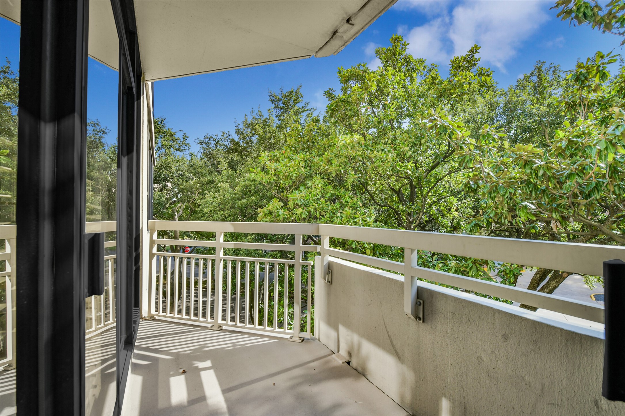 The primary and the secondary bedroom have access to the private balcony with tree top views.