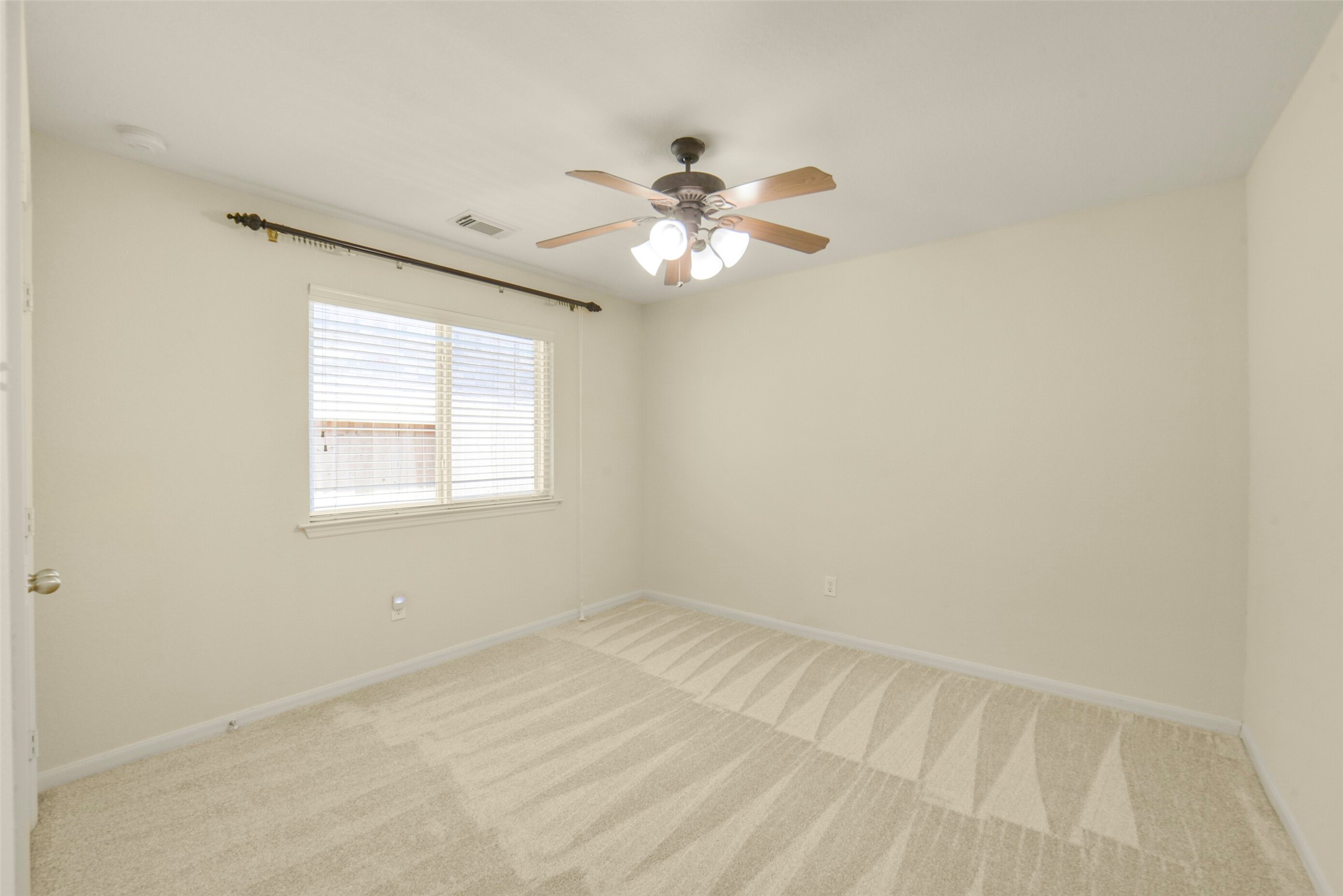 Secondary bedroom with a ceiling fan and dual closets, offering ample storage and comfort.