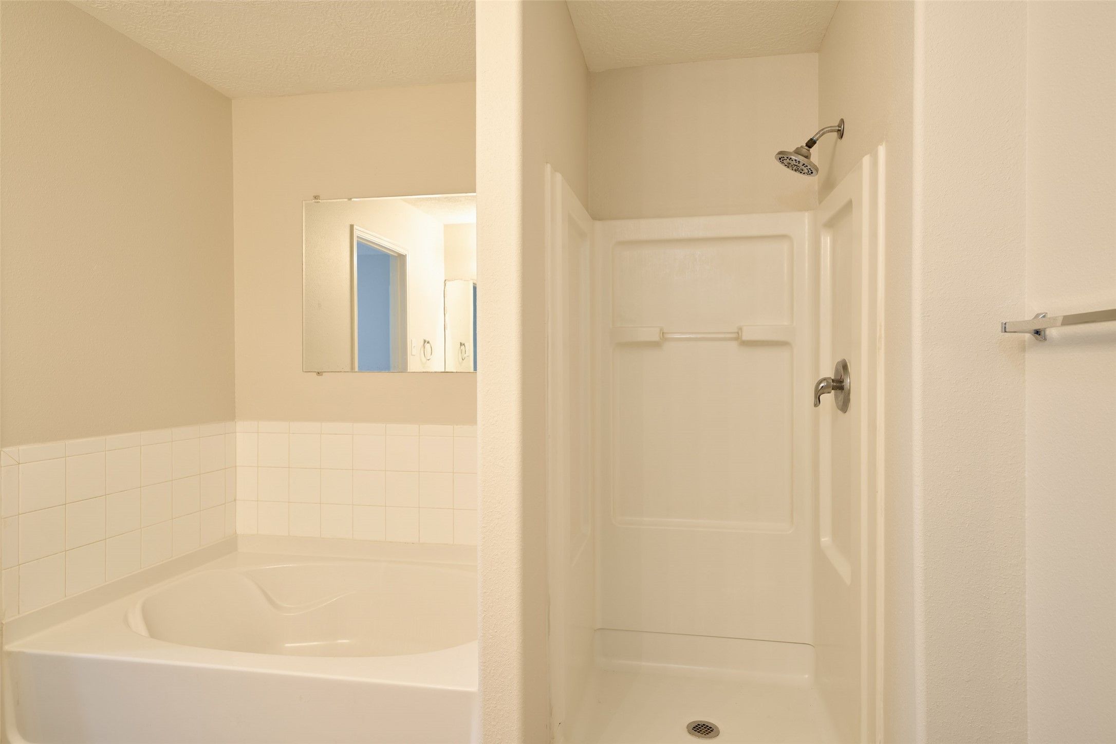 Primary bathroom has separate large tub and stand up shower