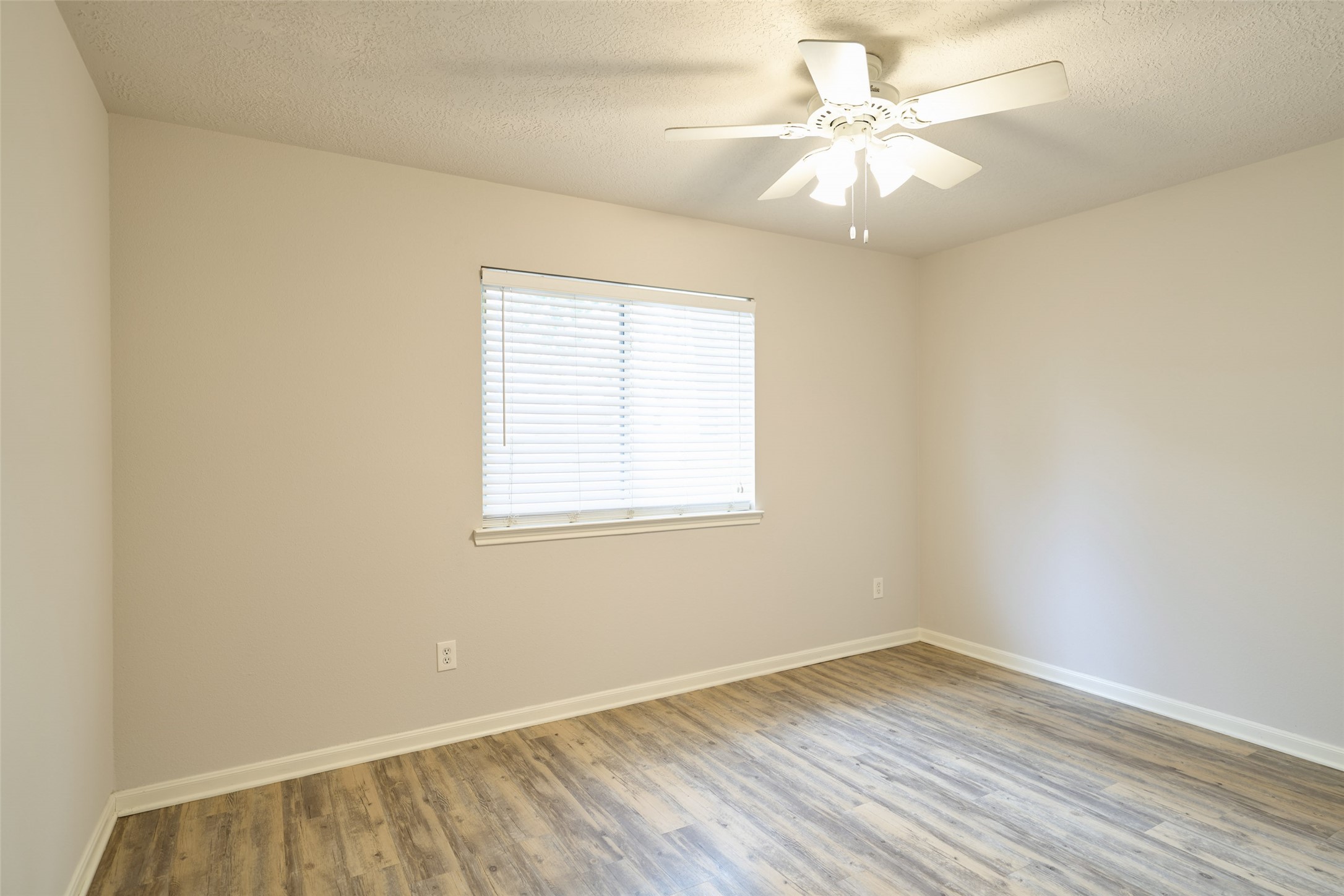 Secondary bedroom in the back of the home overlooking the backyard.
