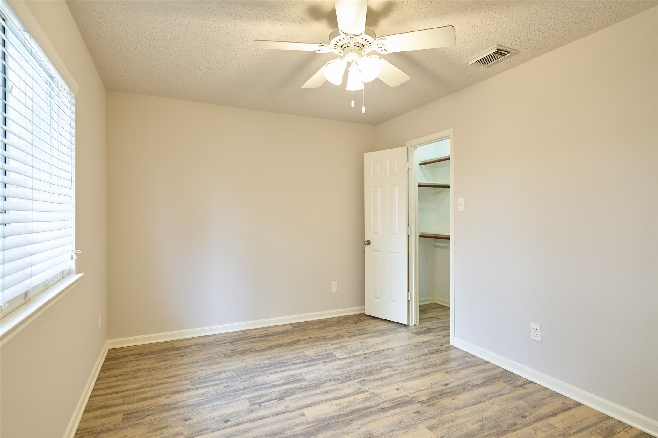 Secondary bedroom in the back of the home overlooking the backyard.