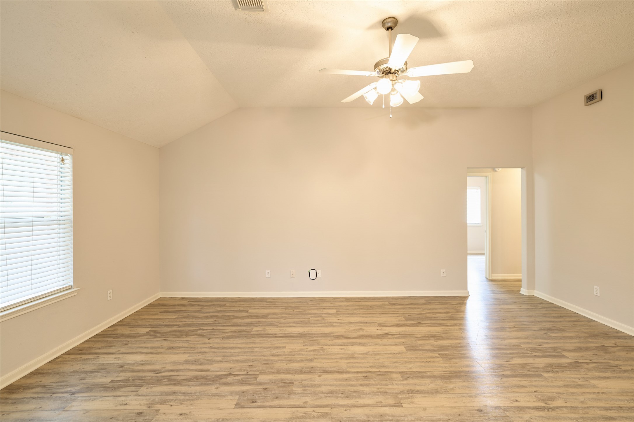 View of living room towards hallway leading to secondary bedrooms.