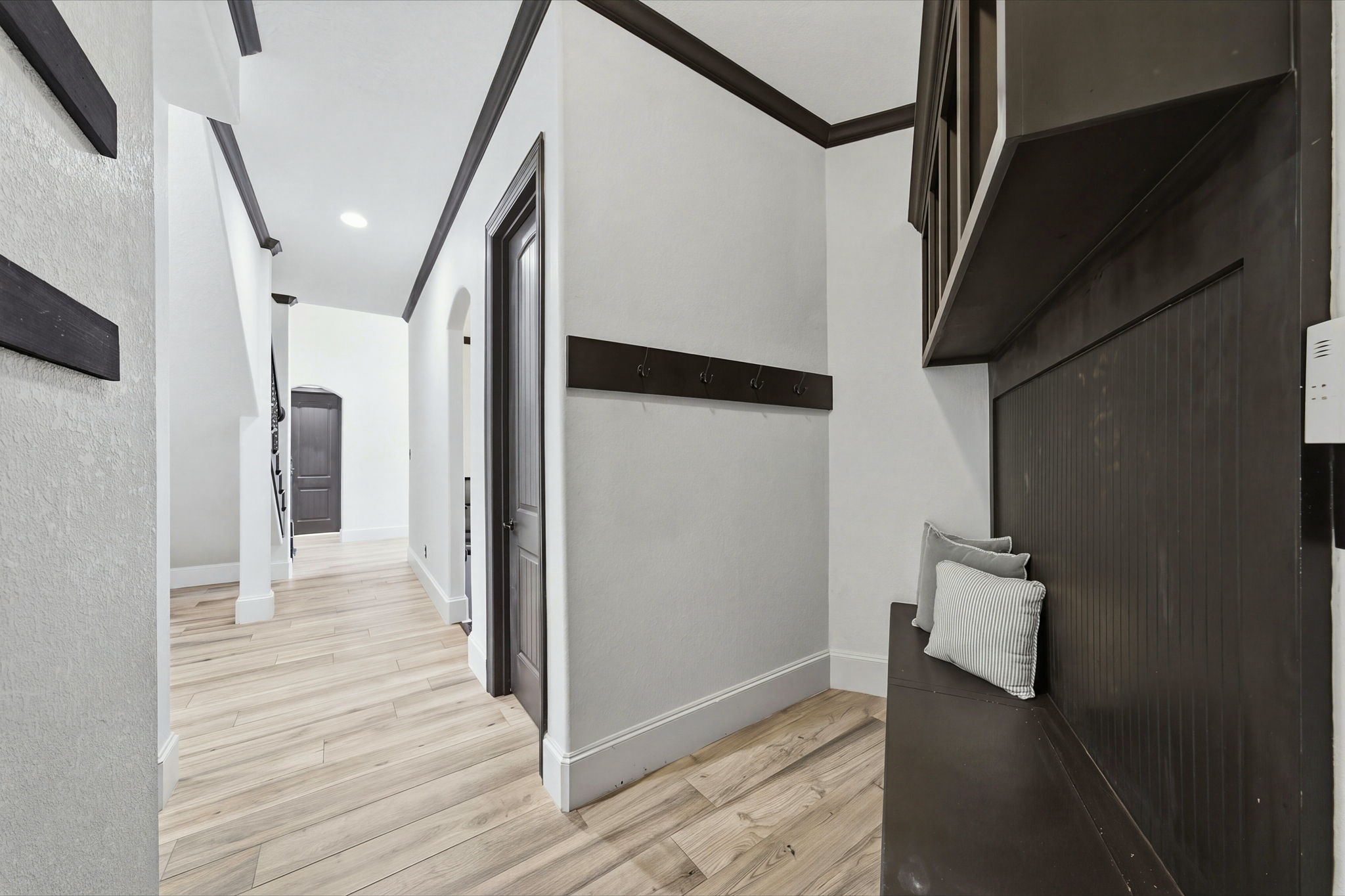 A spacious mudroom offers a convenient drop zone for shoes, bags, and everyday essentials, helping keep the rest of the home organized.