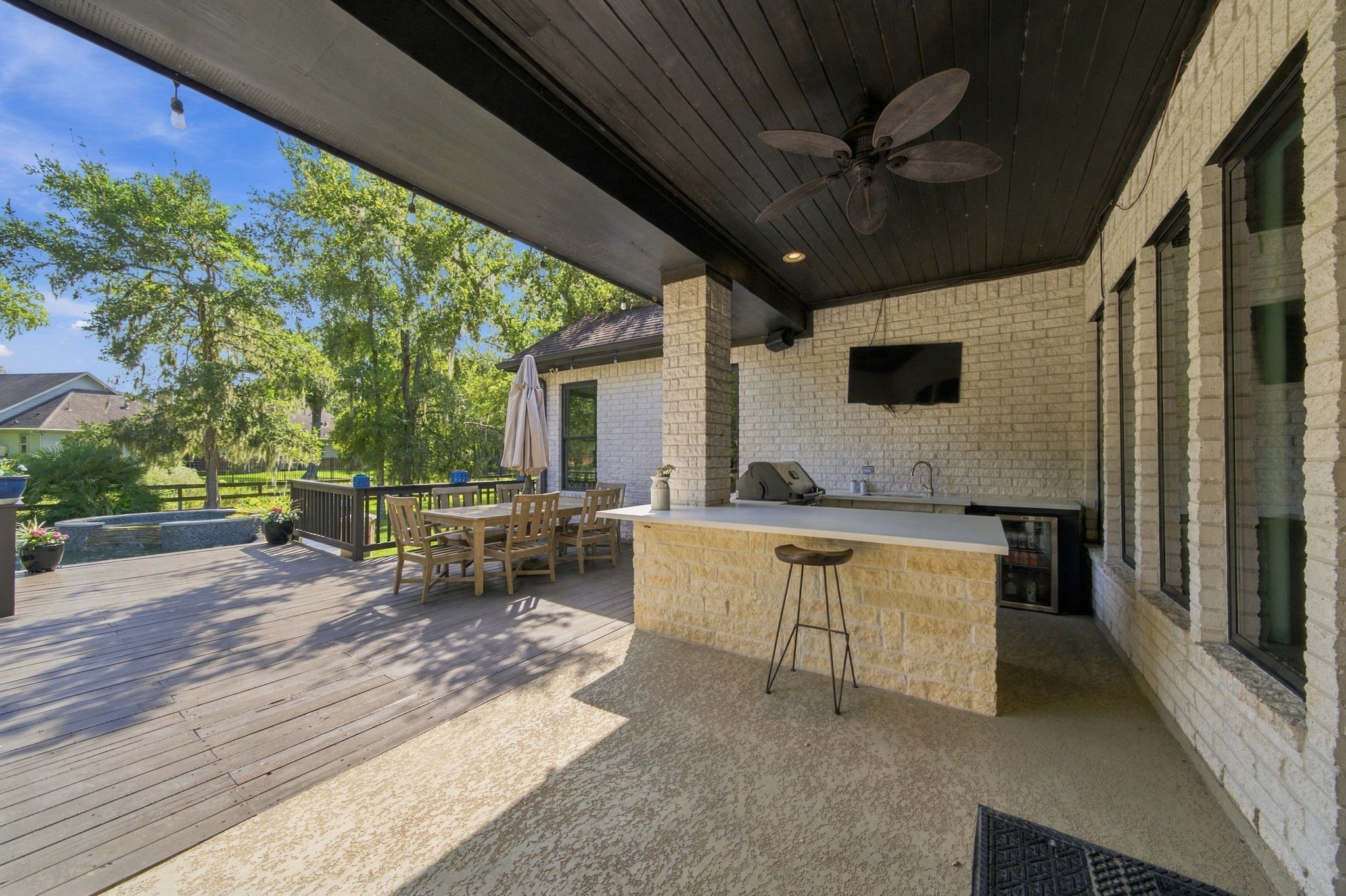 An expansive covered patio and outdoor kitchen make backyard dining and entertaining easy.