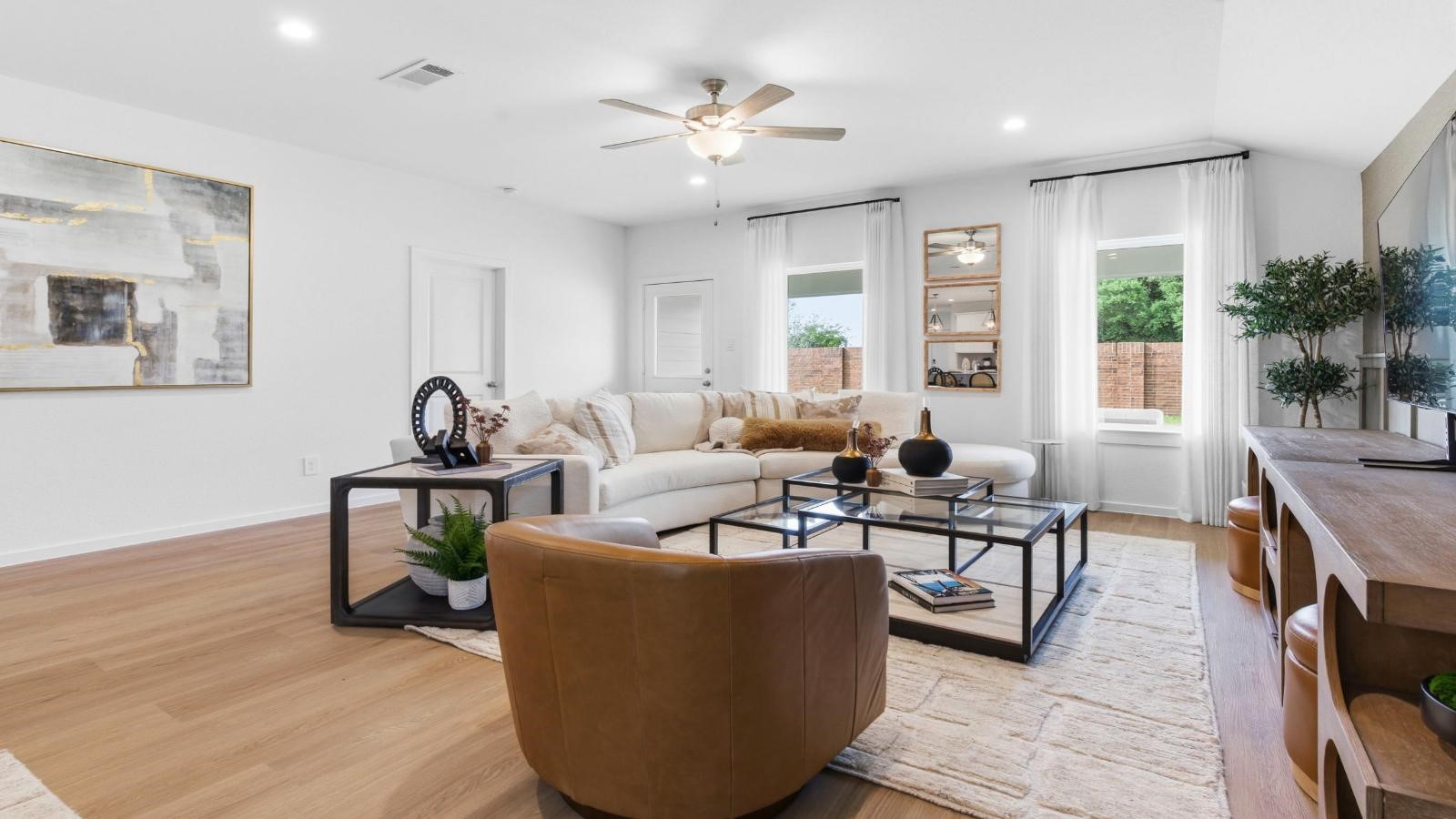 A well-organized living room that includes a kitchen and dining area, creating a warm and welcoming environment for gatherings.