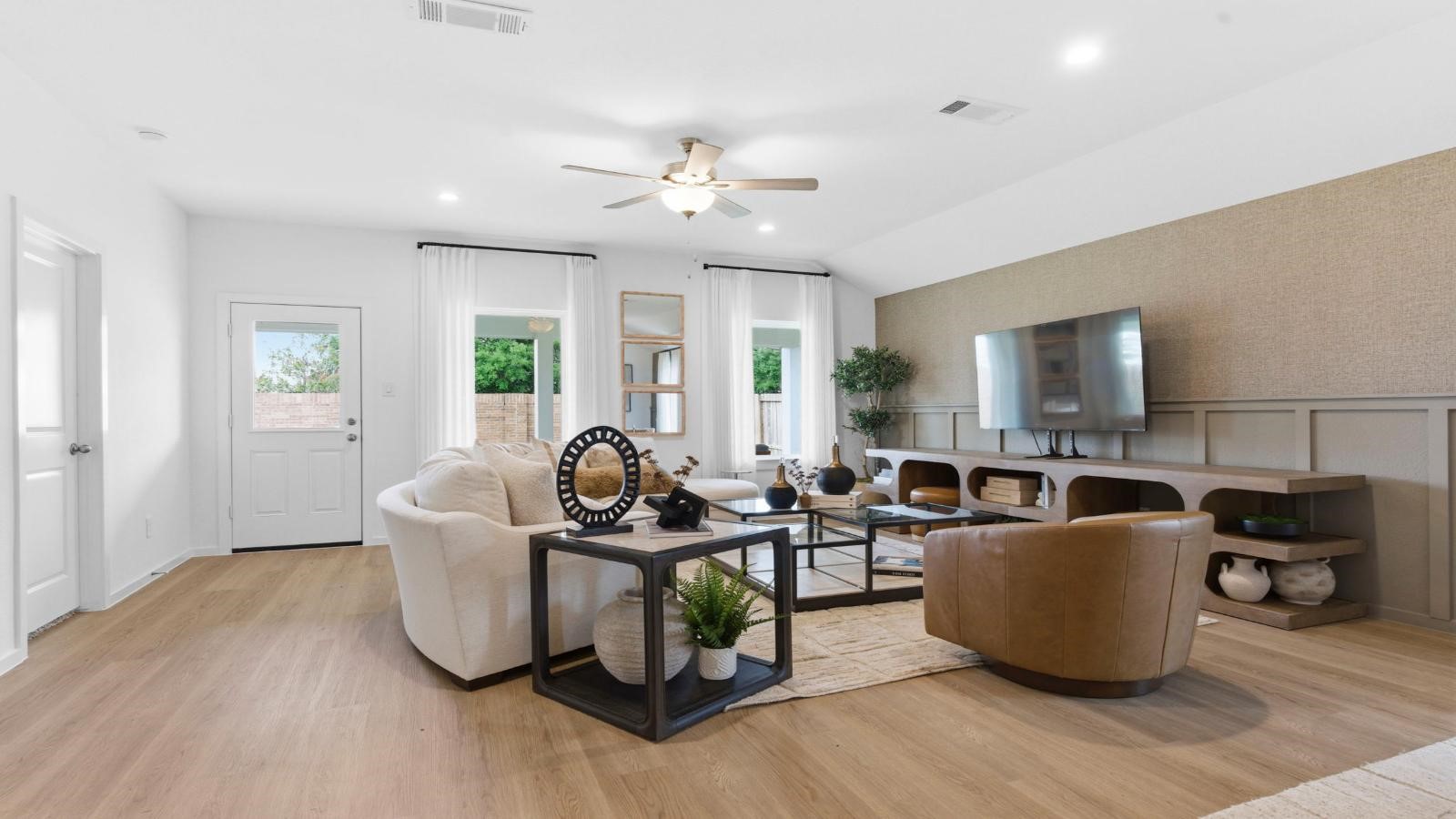 A cozy living room featuring a comfortable couch, a stylish coffee table, and an elegant painting on the wall.