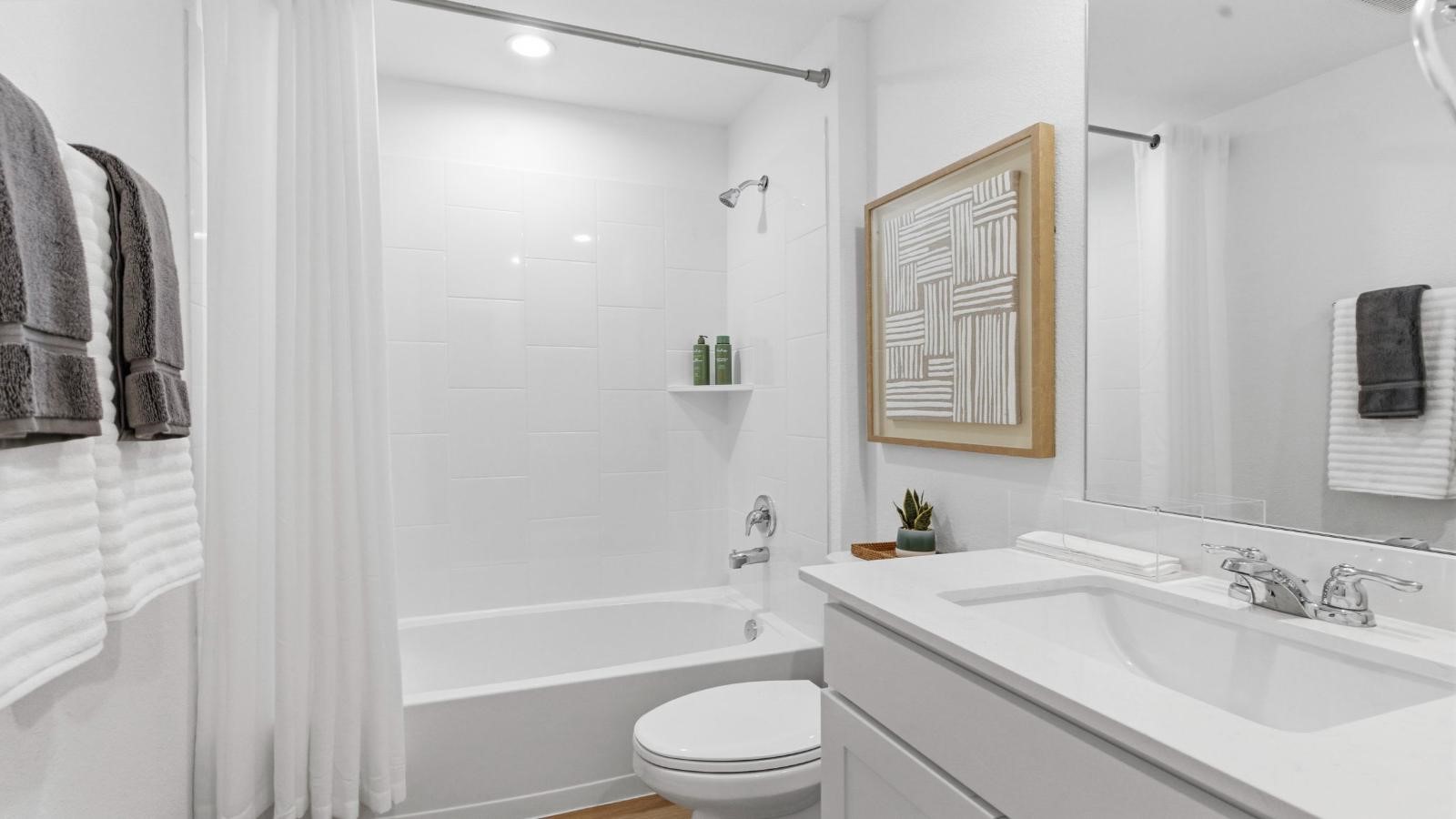 A well-designed bathroom equipped with quartz countertops, a standing tub, and a single vanity. A well-designed bathroom equipped with quartz countertops, a standing tub, and a single vanity.