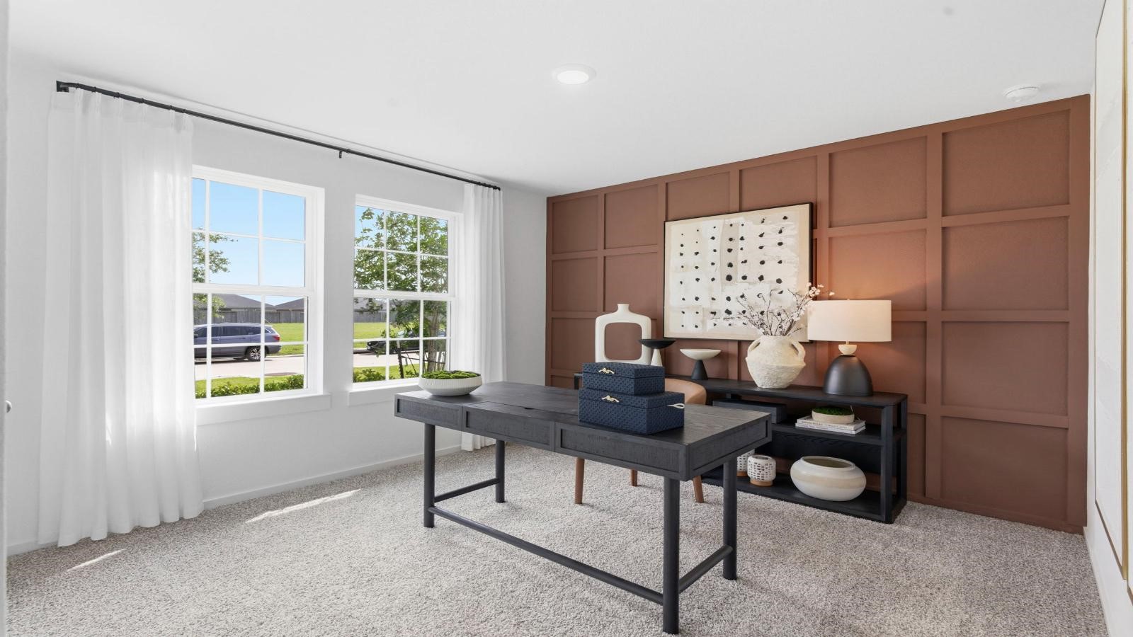 A spacious upstairs living area with plenty of natural light from windows overlooking side of the home