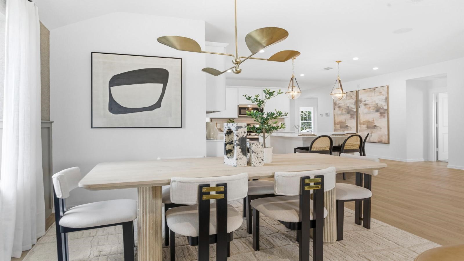 Spacious dining area with vinyl wood flooring, large window and a tall ceiling