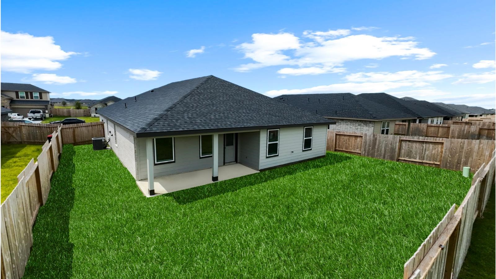 Large fenced-in backyard with a covered patio, perfect for outdoor entertaining.