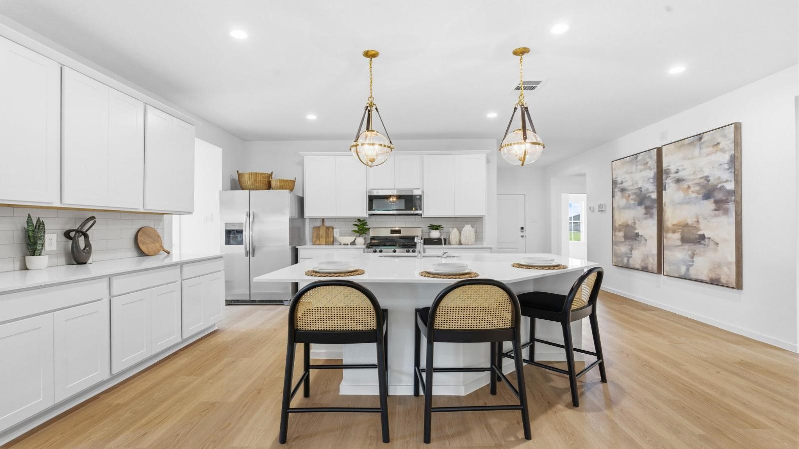 Bright and spacious kitchen with quartz countertops, stainless steel appliances, and an island with bar seating. Bright and spacious kitchen with quartz countertops, stainless steel appliances, and an island with bar seating.
