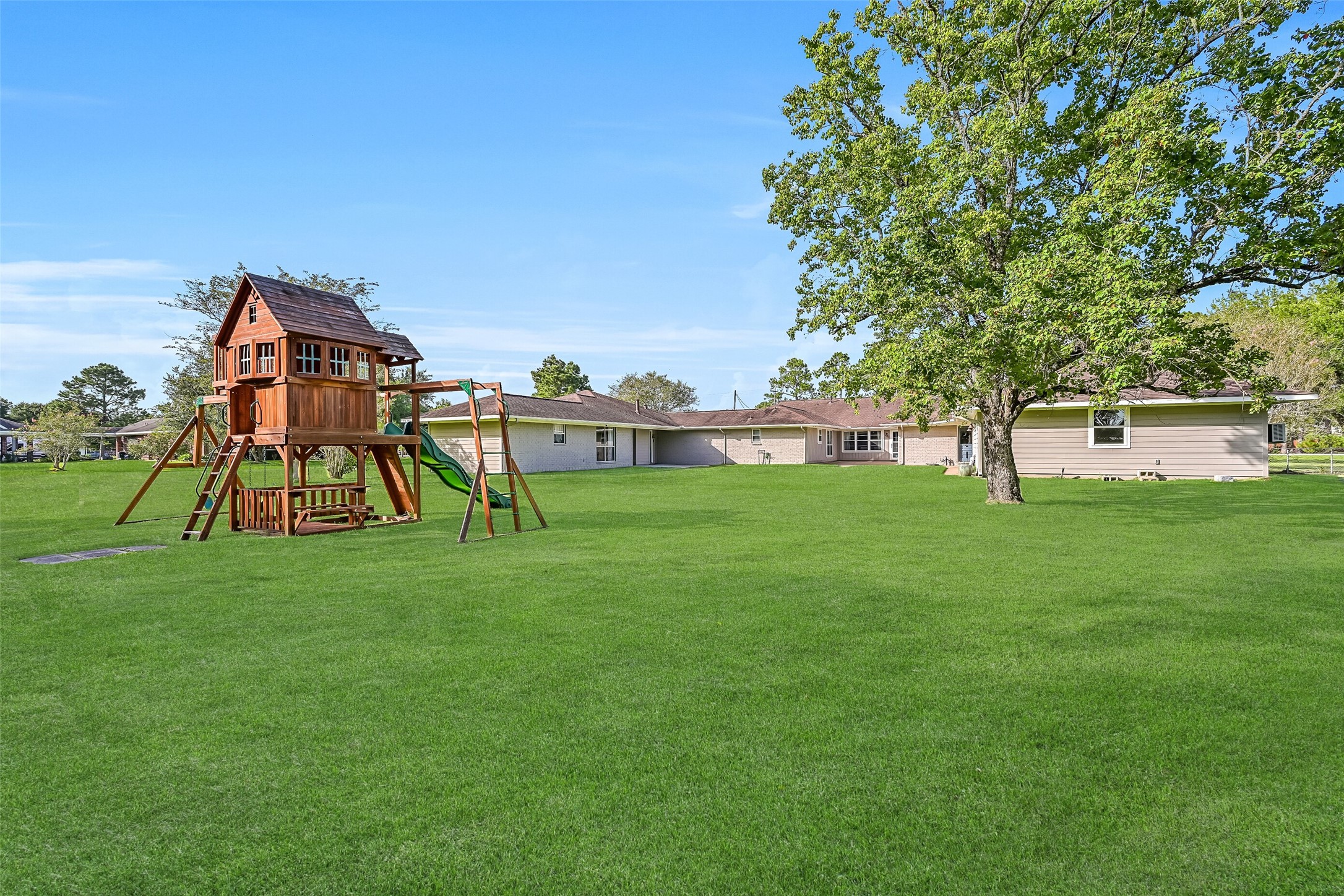 Rear Elevation:
The rear elevation highlights the unique dual-residence layout set across a spacious, level 1.3-acre lot in gighly acclaimed Friendswood ISD. Both residences are positioned to maximize privacy and functionality, with expansive lawn space between and beyond the homes, mature trees, and multiple patio areas.