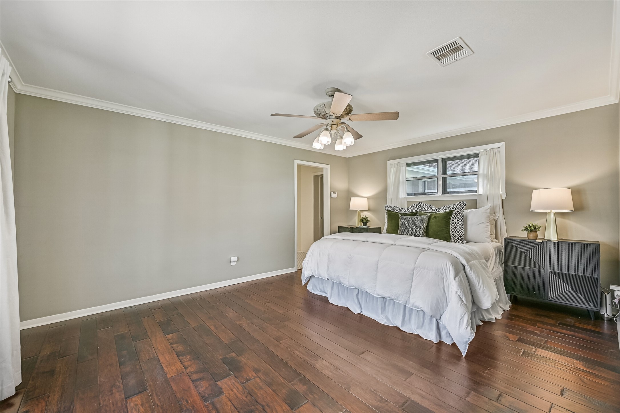 Owners Retreat  First Residence:
Escape to the spacious owners retreat featuring rich wood flooring, crown molding, neutral paint tones, and a lighted ceiling fan. Large windows provide natural light & patio views, while the generous layout easily accommodates a sitting area.