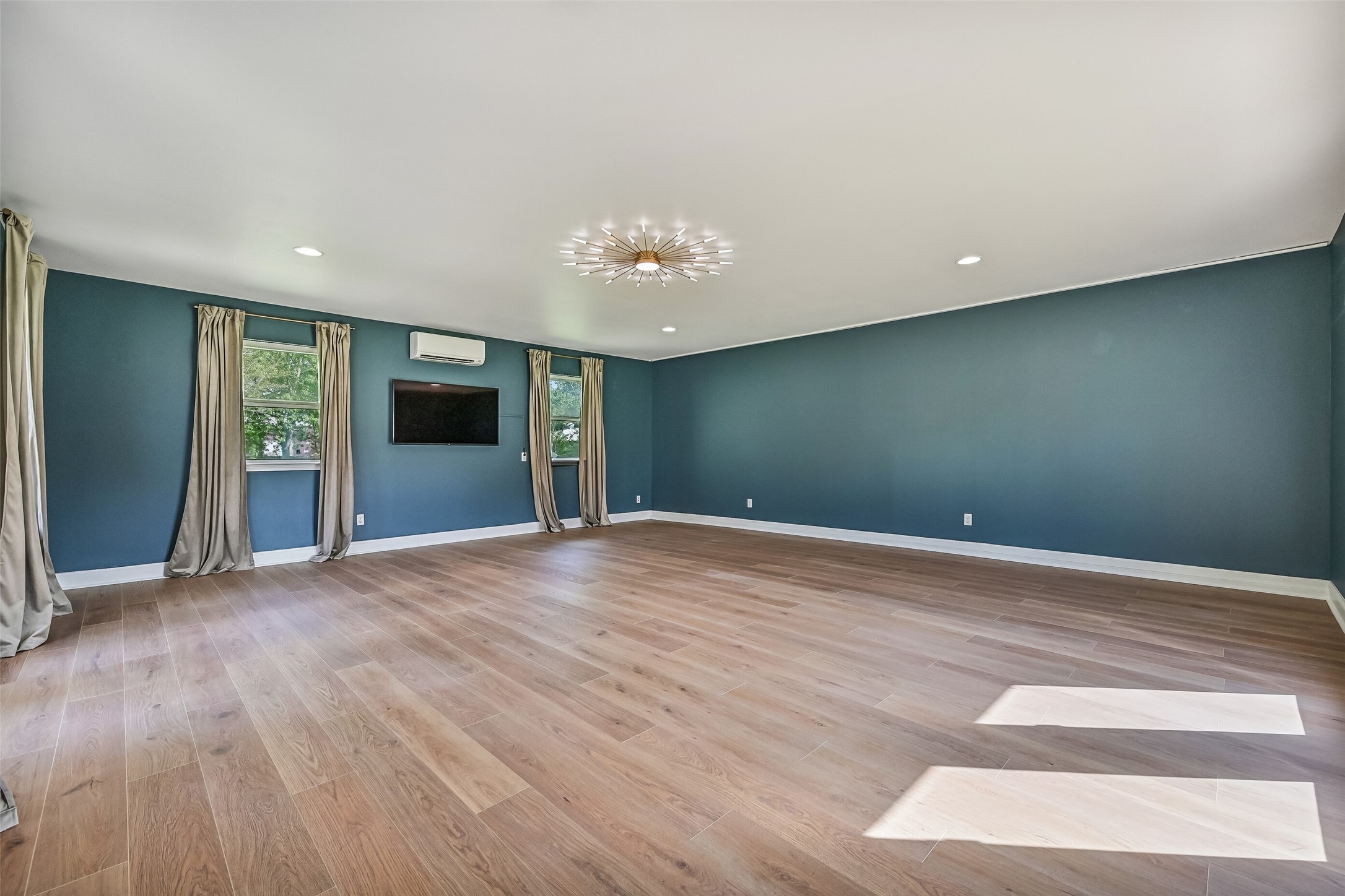 Converted Garage  Finished Flex Space:
Formerly a two-car garage, this fully finished and air-conditioned flex space offers exceptional versatility and scale. Featuring wood-look flooring, recessed lighting, statement ceiling fixture, multiple windows for natural light, and French door access, the space has previously been used as both an art studio and music room.