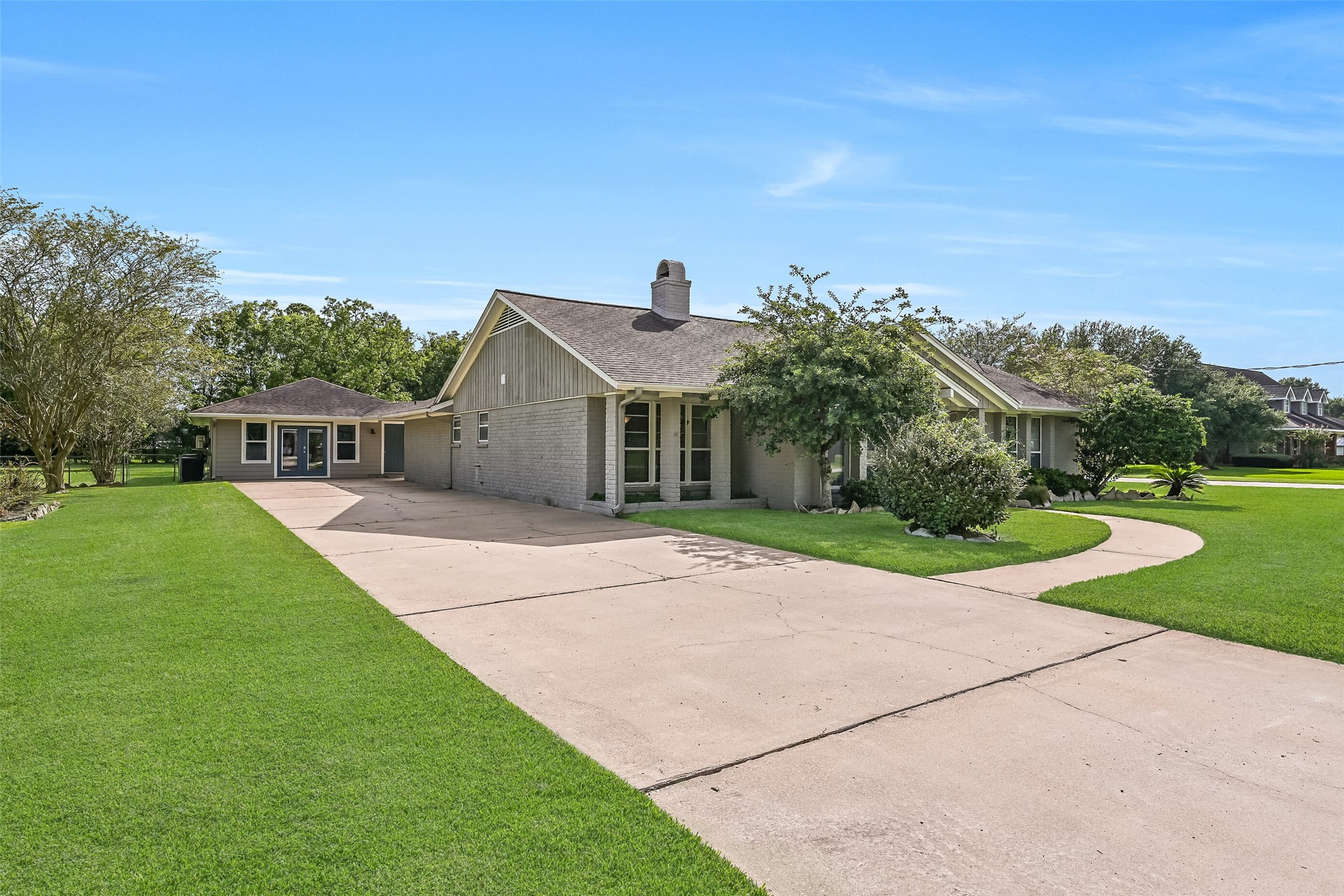Front / Driveway / Converted Garage  First Residence:
A double wide driveway offering ample parking leads to the former two-car detached garage that has been converted into a finished, air-conditioned bonus space, ideal for use as an art studio, music room, gym, or home office.