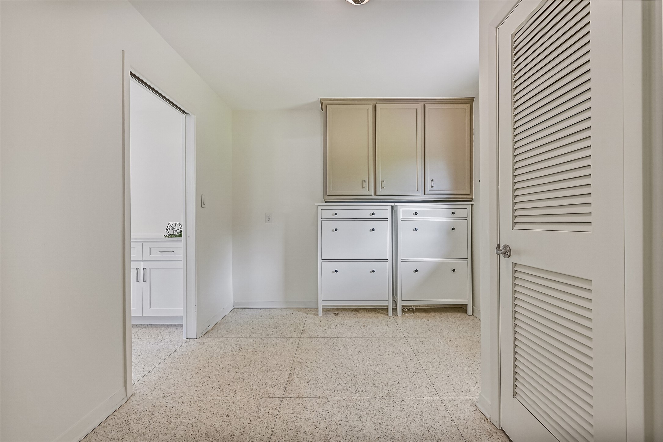 Mudroom & Half Bath  First Residence:
Just inside the rear entry and off of the kitchen, this well-designed mudroom offers built-in cabinetry and ample storage, creating an ideal drop zone with convenient access, as well as a half bathroom.