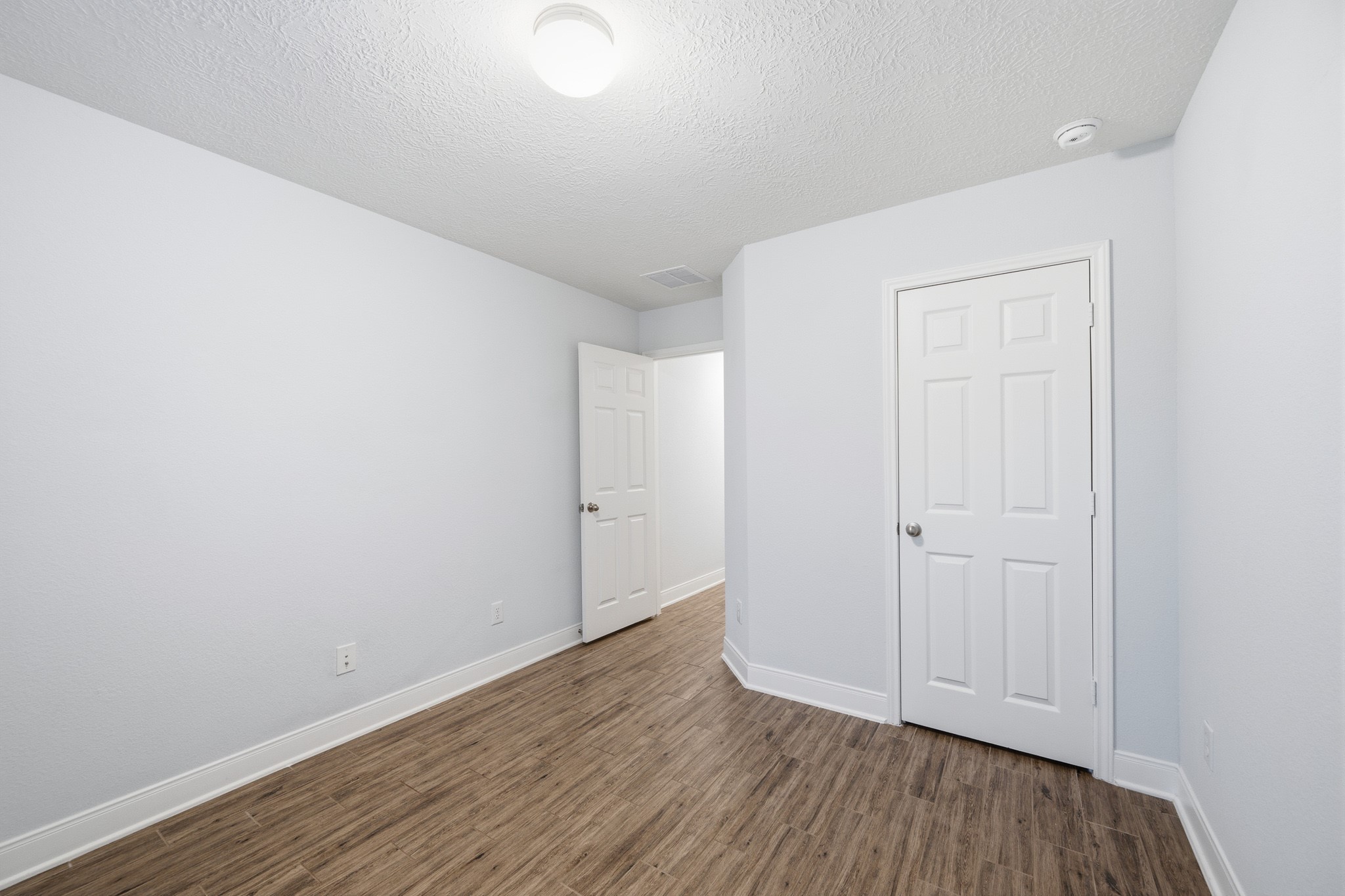 Bedroom 3 offers a cozy retreat with its sleek flooring and crisp white walls, ready to be personalized to your taste.