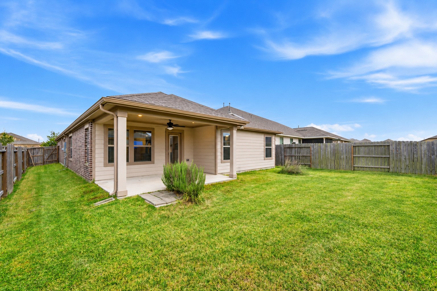 Experience outdoor bliss in this inviting backyard, featuring a cozy patio perfect for relaxation.