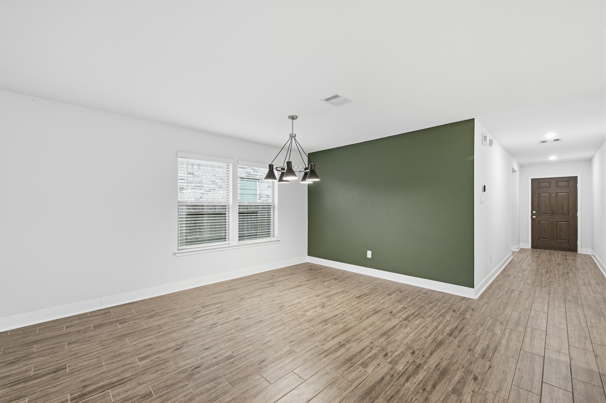 Bright and inviting, this breakfast area features a stylish modern light fixture and beautiful flooring, perfect for starting your day in comfort.