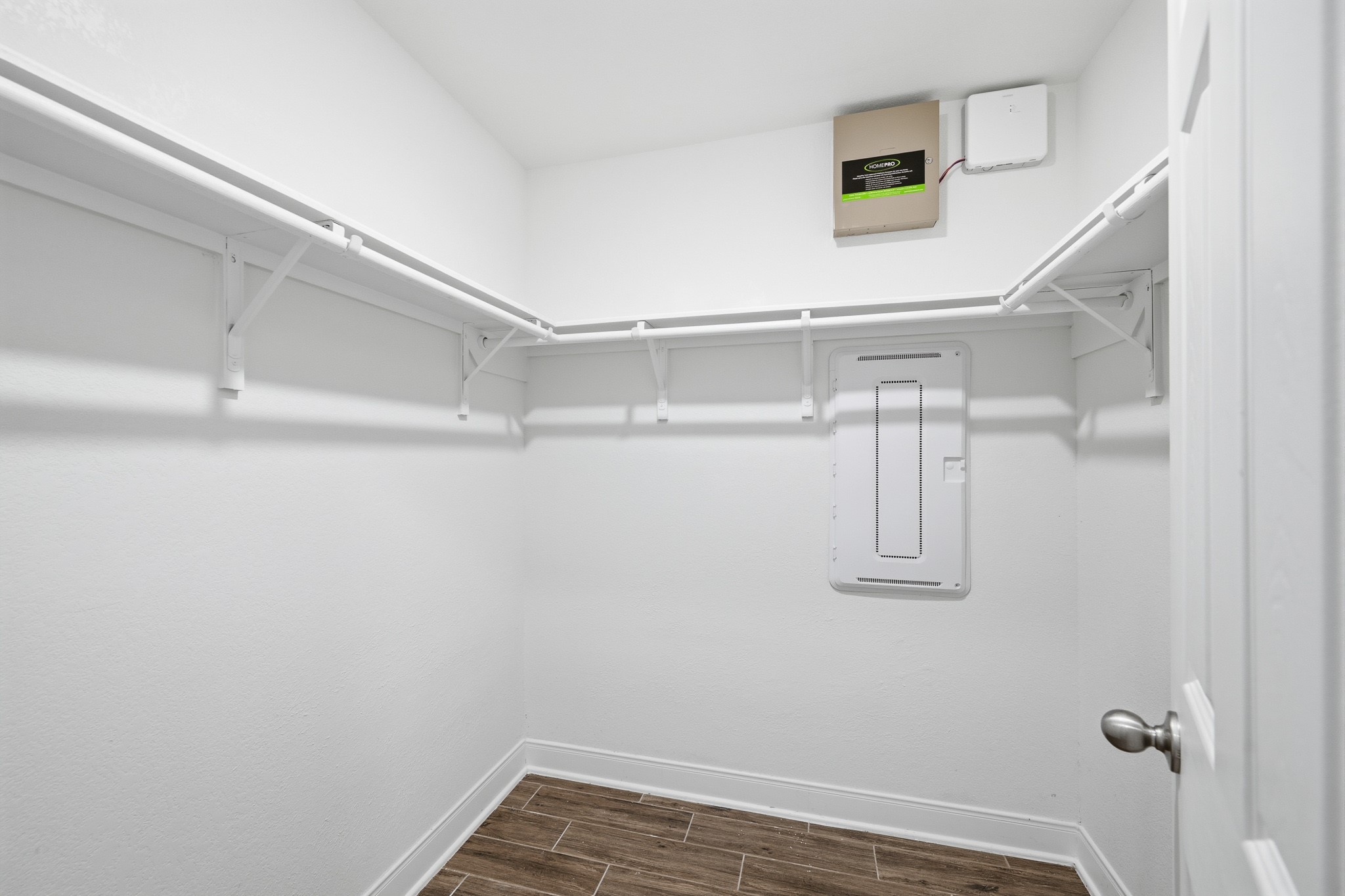 Spacious walk-in closet with ample shelving and clean, modern design.