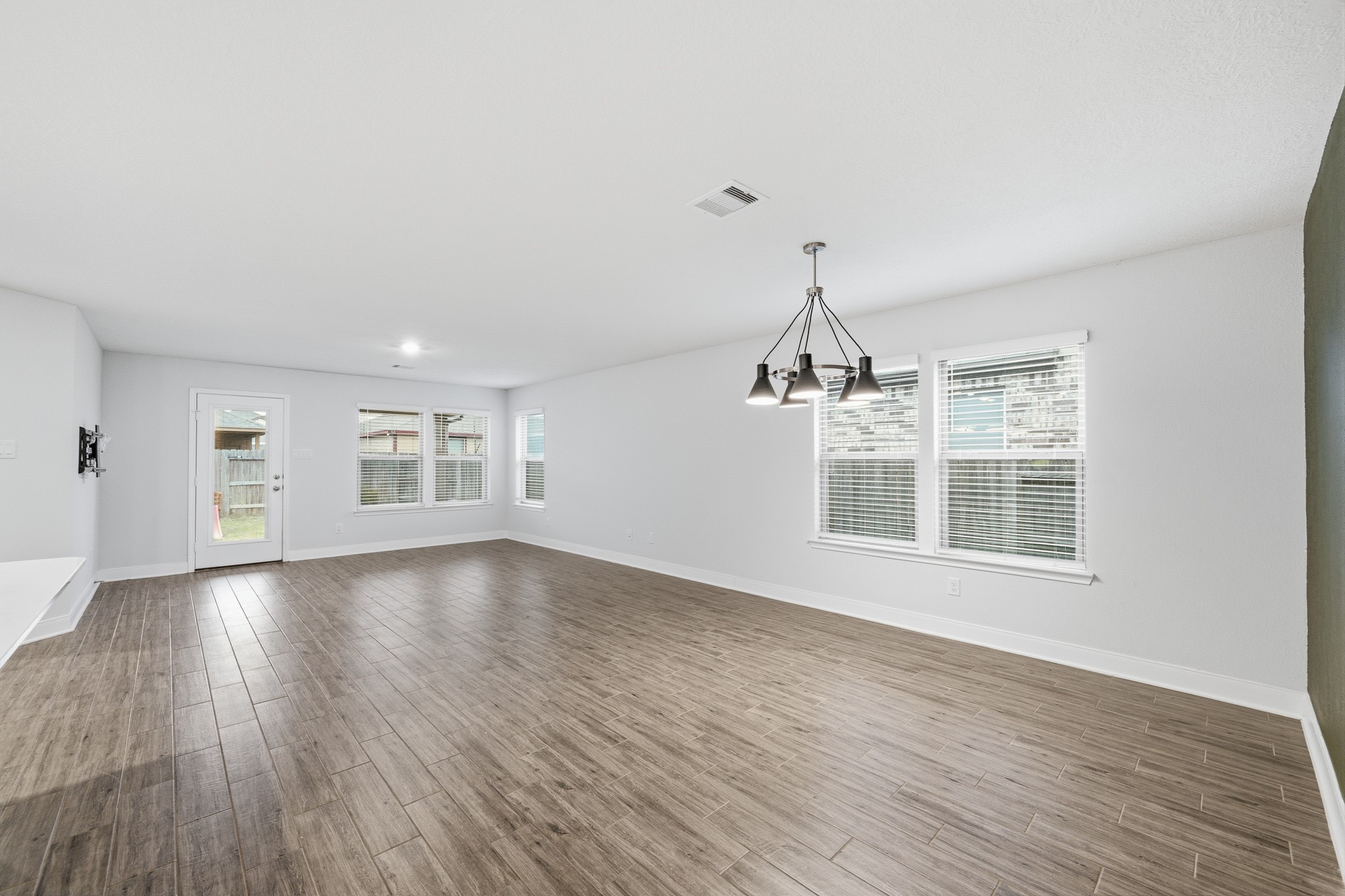 Expansive living area seamlessly integrates with a cozy breakfast nook, offering the perfect blend of space and comfort for everyday living.