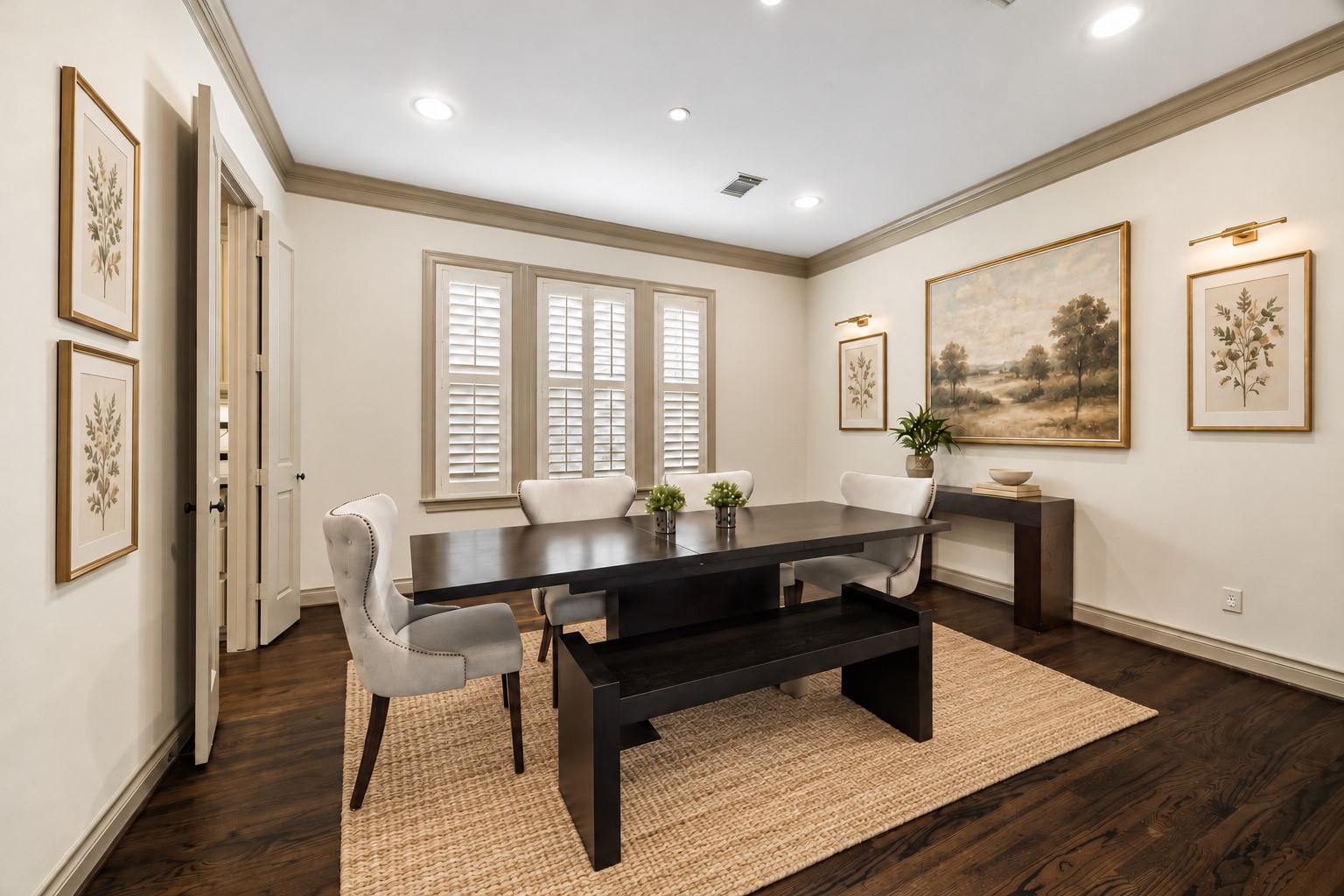 Elegant light-filled formal dining room thoughtfully positioned to the right of entry, creating a wonderful flow for entertaining. Three large windows w/ plantation shutters fill the space w/ natural light while hardwood flooring, crown molding & recessed lighting enhance the timeless design. Generous proportions provide plenty of room for large dining furnishings. Virtually staged.
