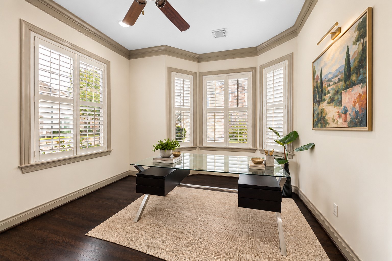 Beautiful light-filled formal living/study located to the left of entry. Four large windows w/ plantation shutters overlook the front exterior. Hardwood flooring, crown molding, recessed lighting, ceiling fan & arched entries enhance the timeless design. Flexible space makes an ideal home office, formal sitting room, playroom or piano room! Virtually staged art.