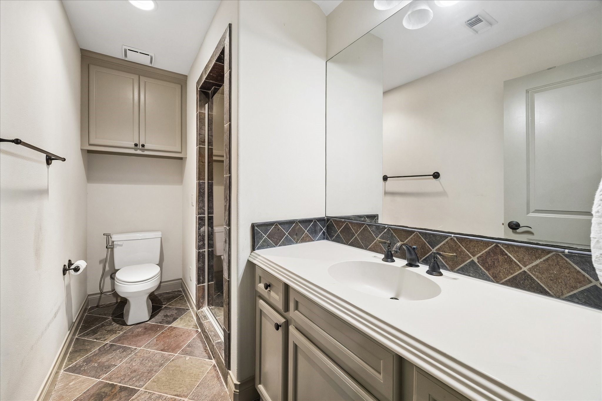 Full bath conveniently located on 3rd floor serving the versatile flex room/4th bedroom. Features separate shower, vanity w/ storage & slate tile flooring. Dedicated bath provides wonderful functionality & privacy, making 3rd floor an ideal guest suite, home office or additional living space.
