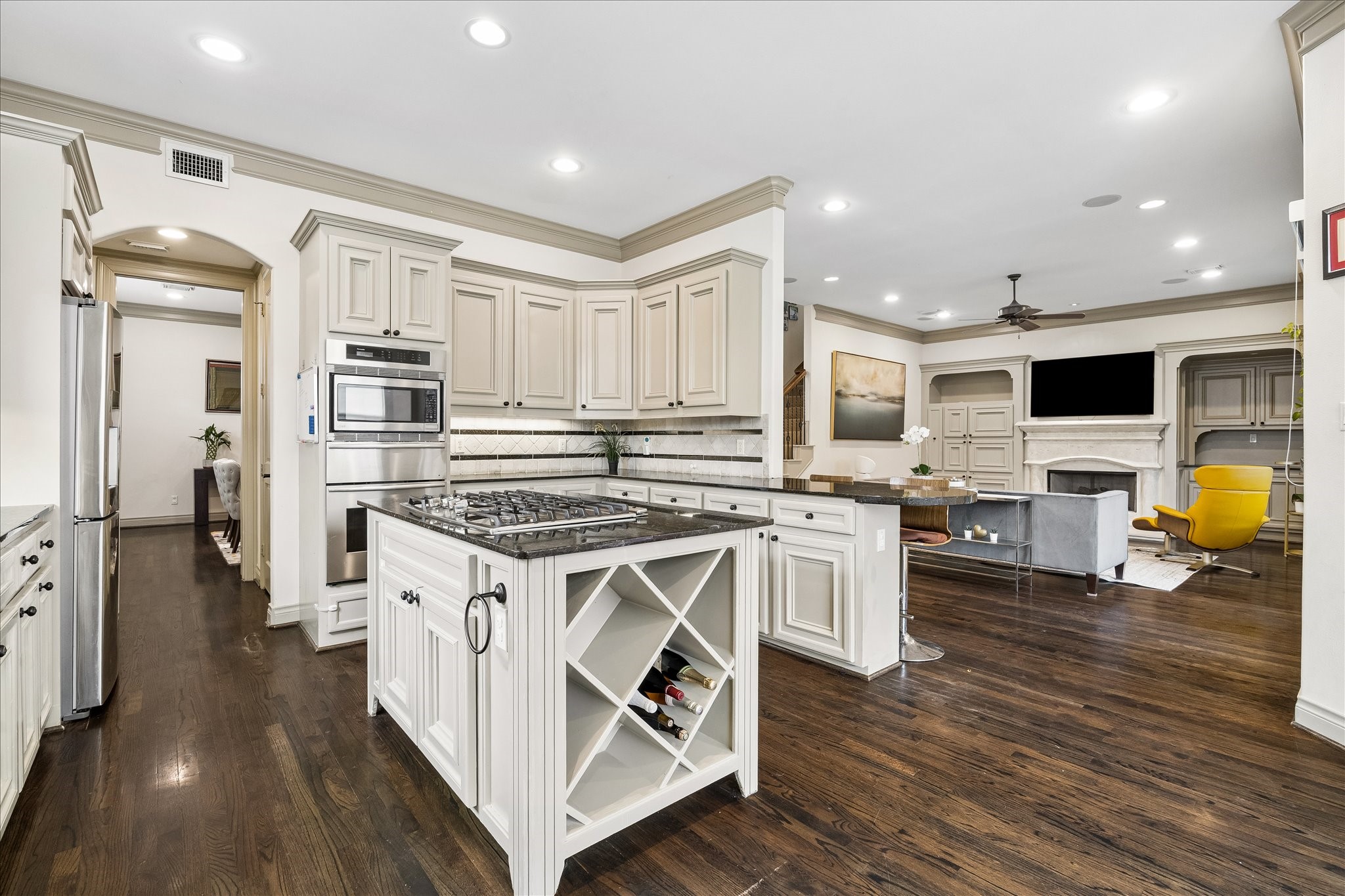 Another view of beautifully appointed kitchen highlighting the stainless steel appliance package including Thermador convection oven, warming drawer, Whirlpool dishwasher '25, LG microwave '21 & Samsung refrigerator included! Water filtration system at sink, under-cabinet lighting & walk-in pantry w/ built-in shelving add everyday convenience. Kitchen opens to breakfast area & family room, offering a wonderful layout for everyday cooking & entertaining.