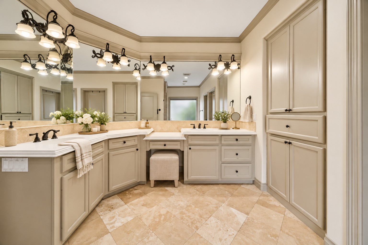 Generously sized primary bath features dual sinks w/ ample counterspace, abundant built-in cabinetry & drawers for storage, and dedicated vanity knee space. Decorative vanity lighting & mirrors complete this thoughtfully designed space. Large walk-in closet w/ built-ins offers excellent hanging & shelving storage. Virtually staged.