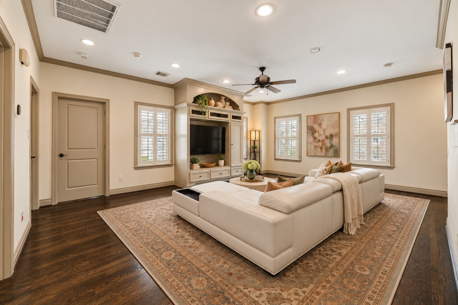 Another perspective of upstairs game room highlighting four windows w/ plantation shutters that fill the space w/ natural light. Open layout provides wonderful flexibility for a variety of furniture configurations, whether used for movie nights, childrens playroom, games or everyday family enjoyment. Virtually staged.