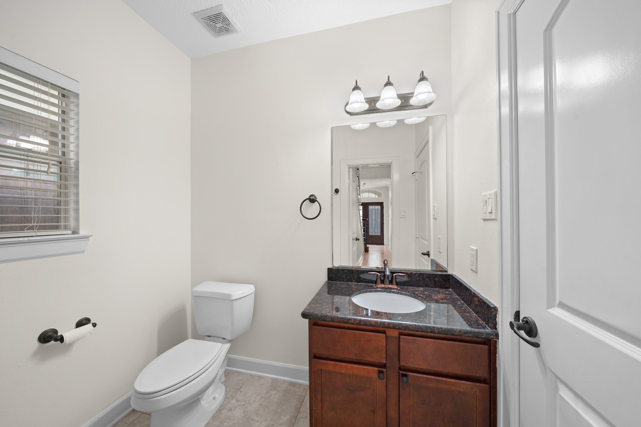 The first floor bathroom has granite countertops.