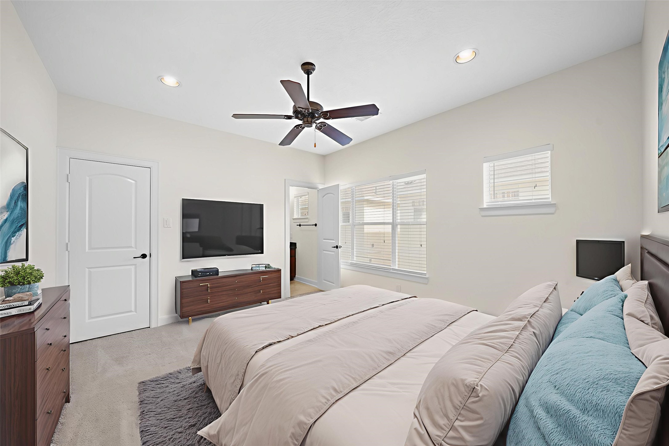 Virtually Staged: Secondary bedroom with carpet floors, recessed lighting, a ceiling fan, and an en-suite bath.