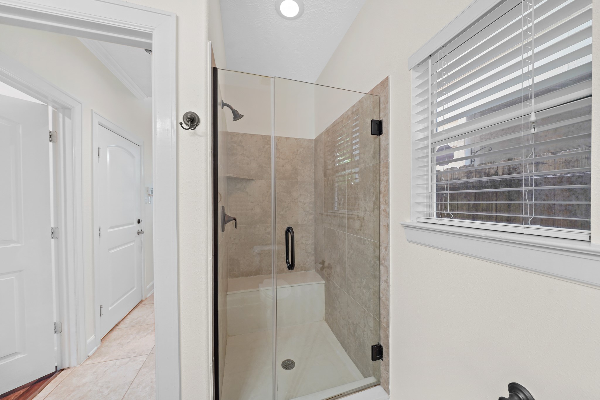 This bathroom also has a gorgeous walk-in shower with a siting area.